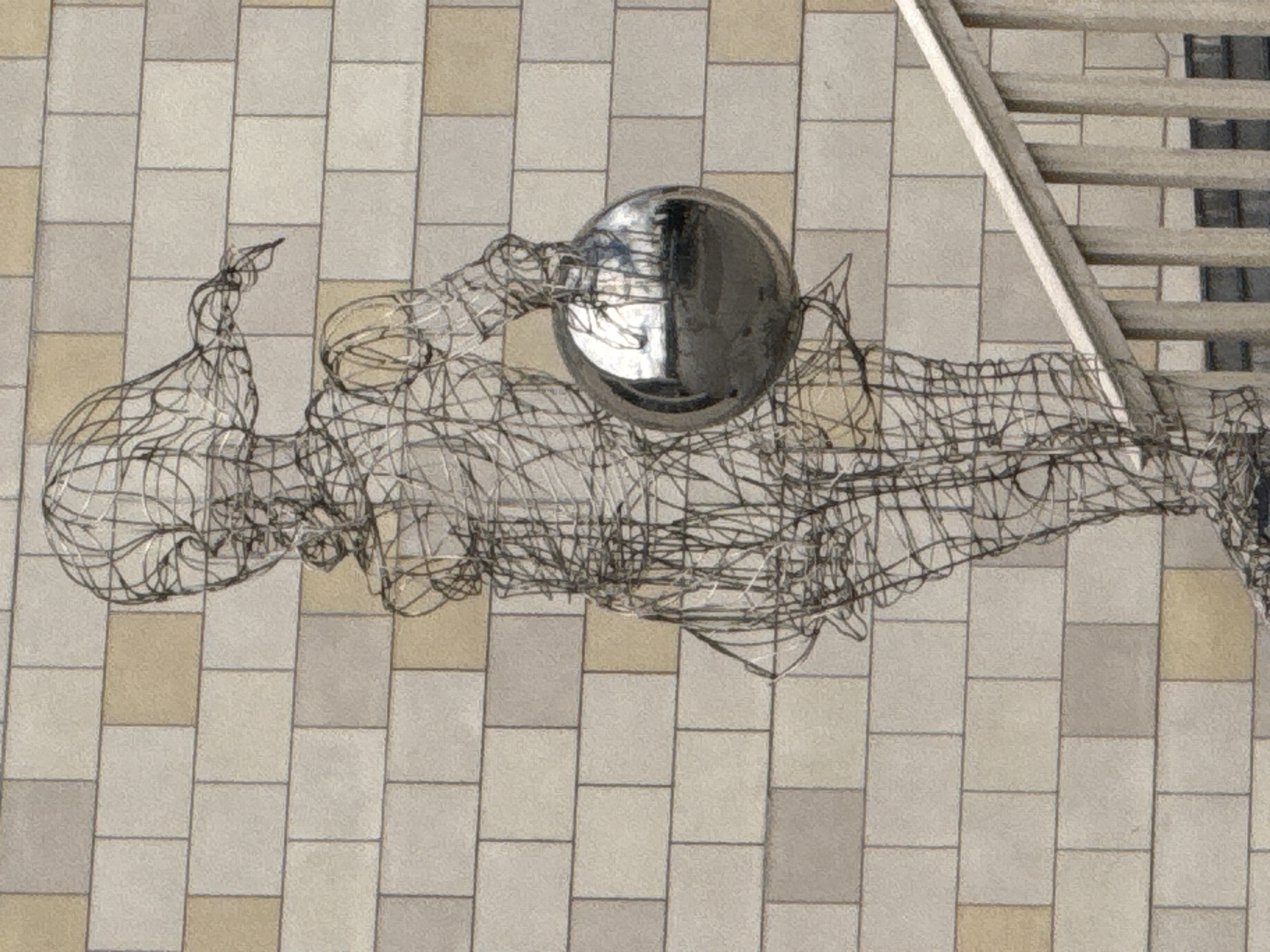 Moscow plaza: fountain play, wire sculptures, and summer crowds