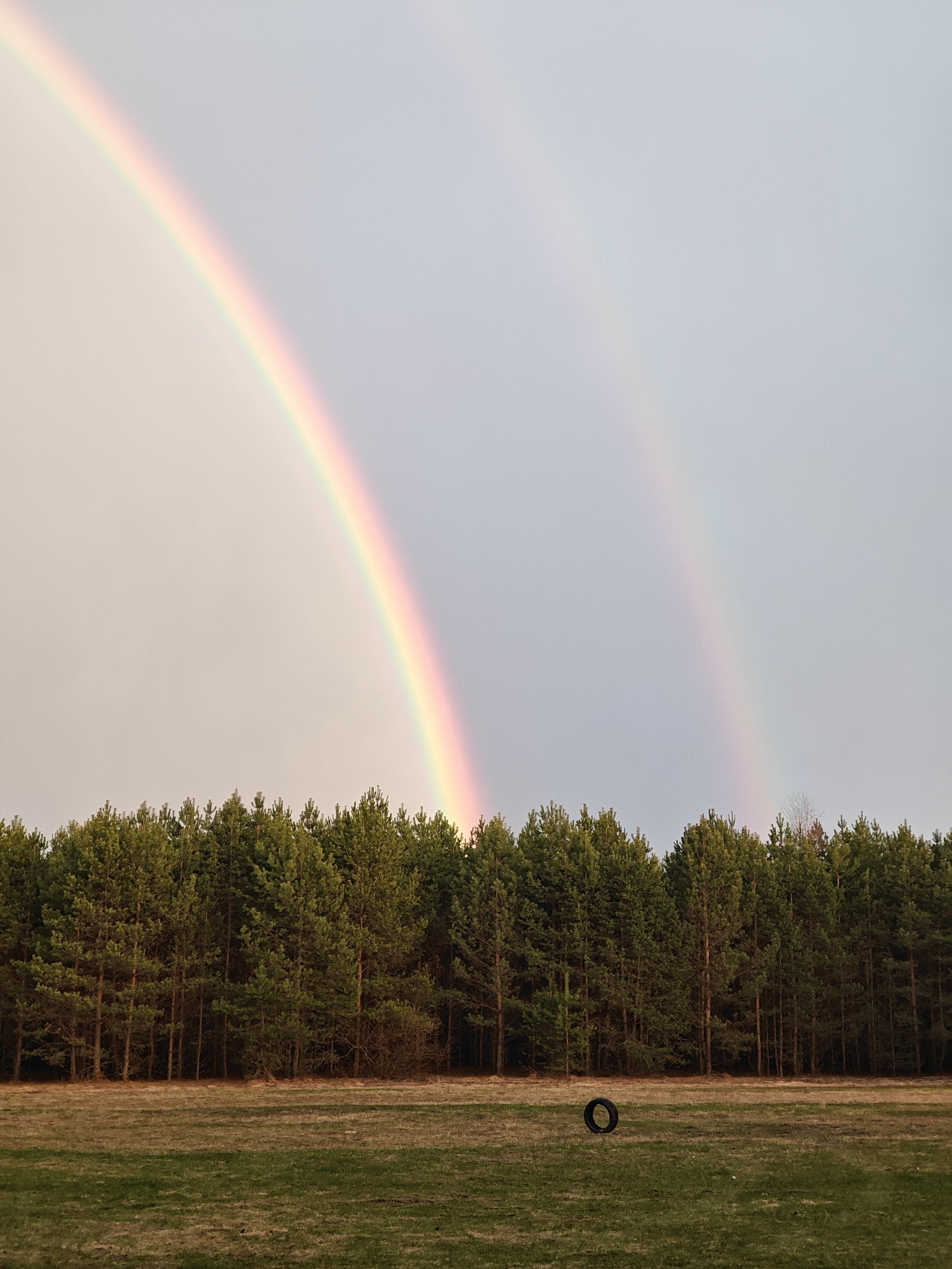 Double rainbow appears over Chaikovsky fields amid overcast skies
