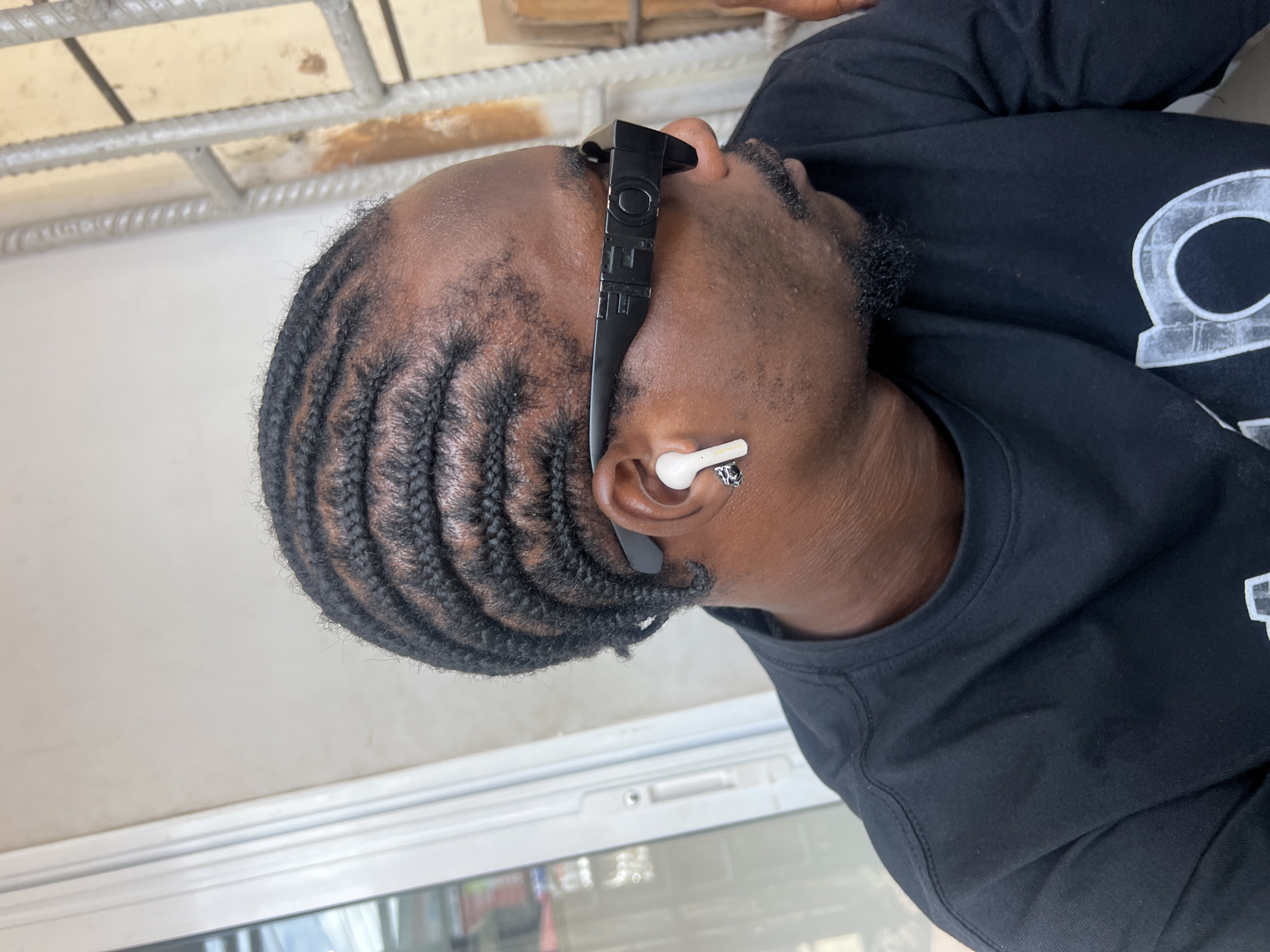 Man photographed wearing OFF sunglasses and earbuds in Ikeja
