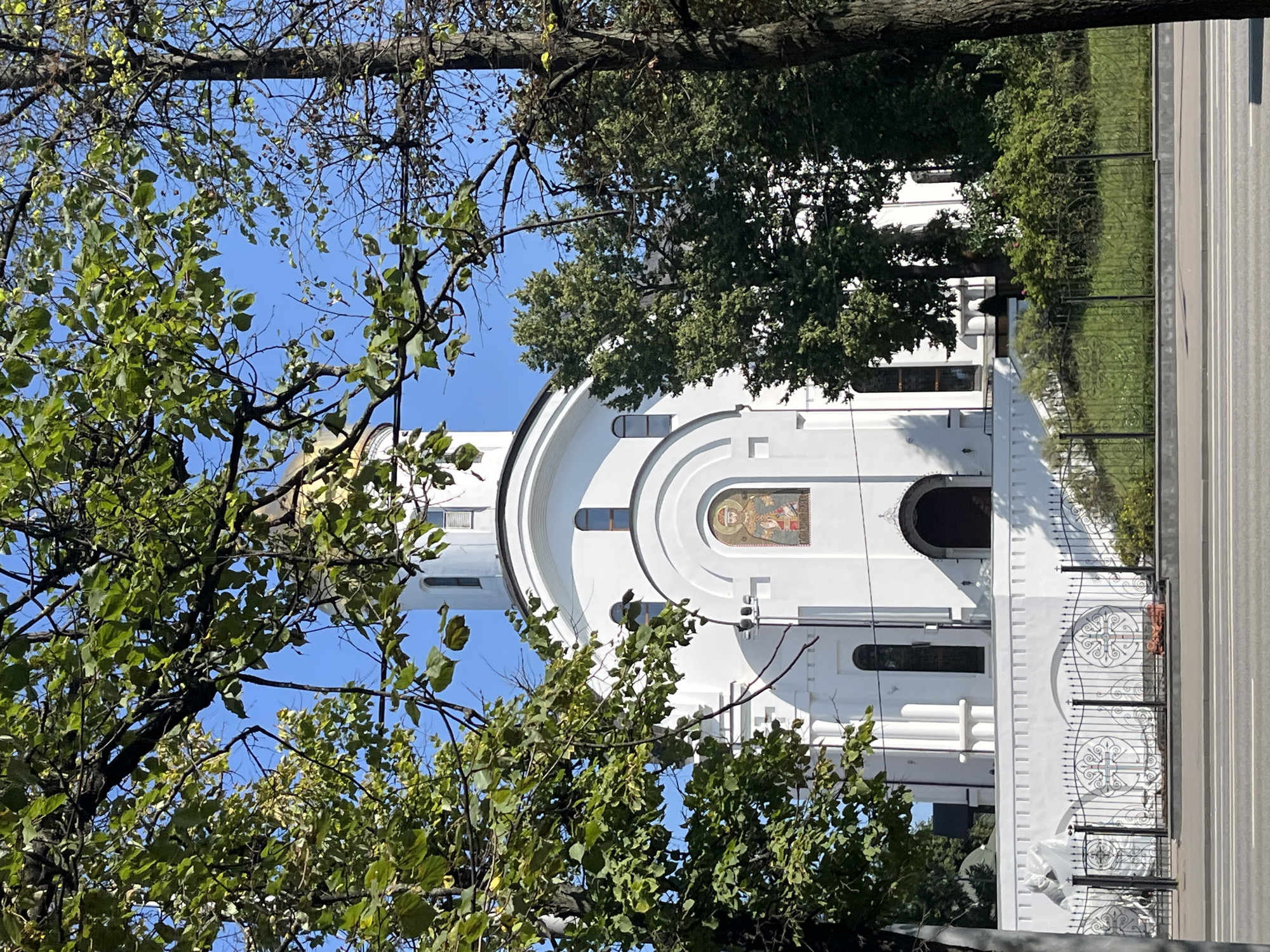 Gold-domed Orthodox church framed by summer greenery in Moscow