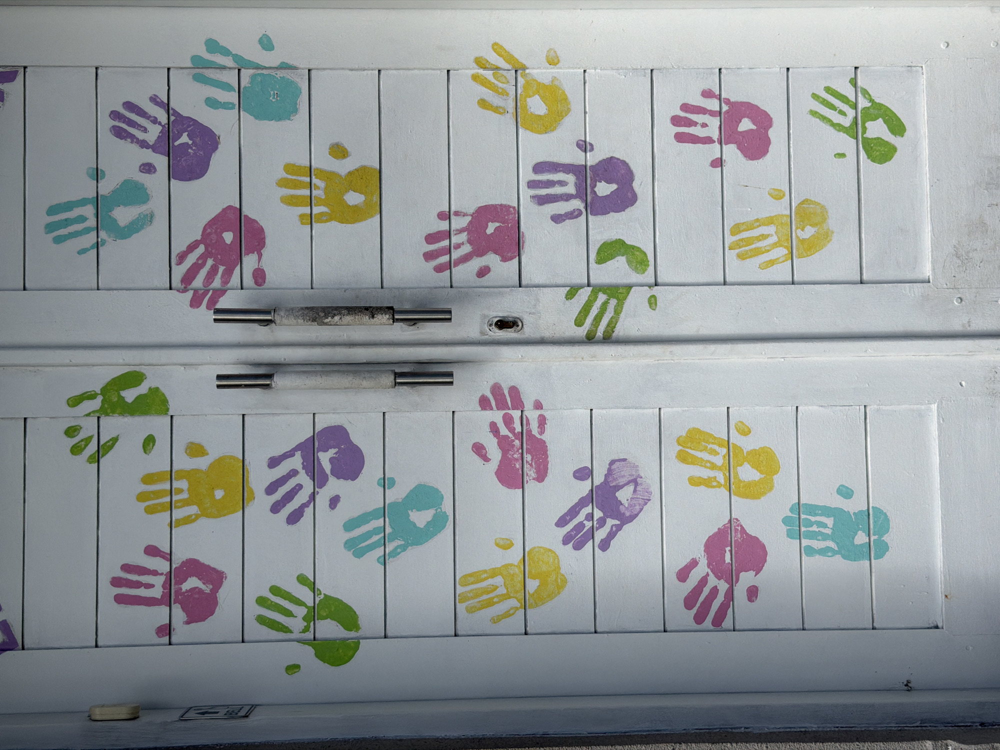 Children's playtime and artwork documented at Kuta facility
