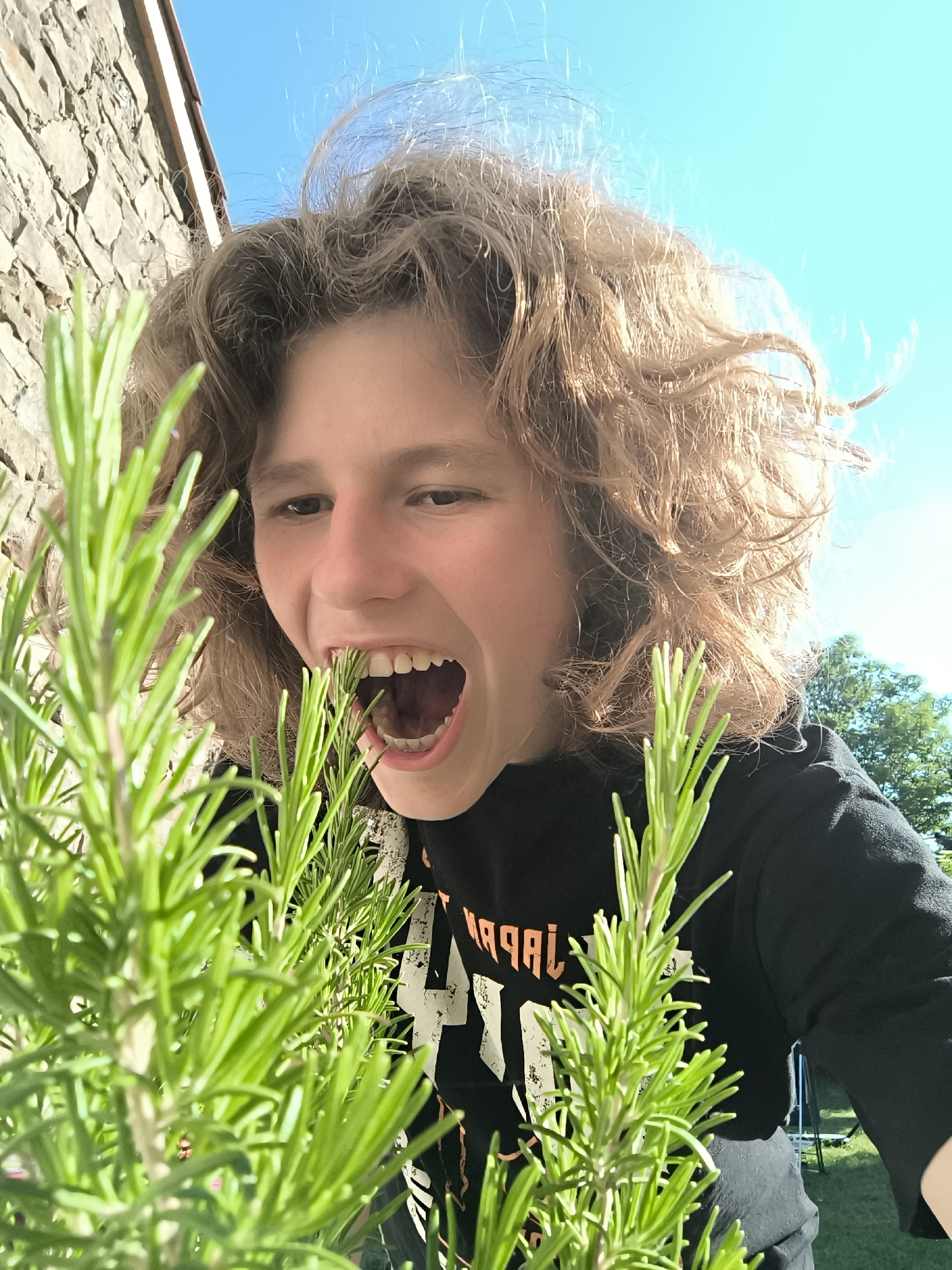 Teen takes playful selfies outside stone building in Pélussin