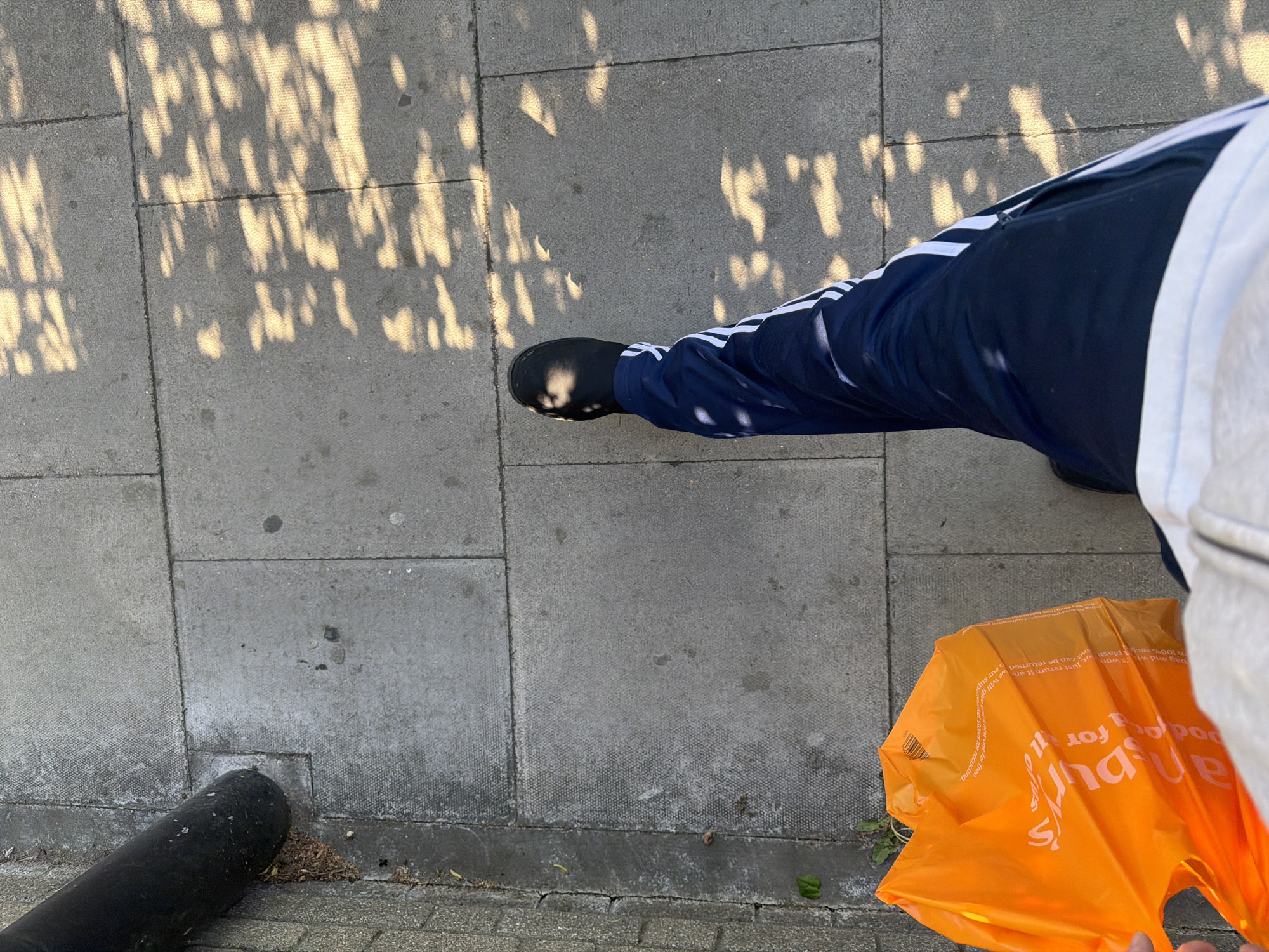 Person photographed on London street during clear spring afternoon