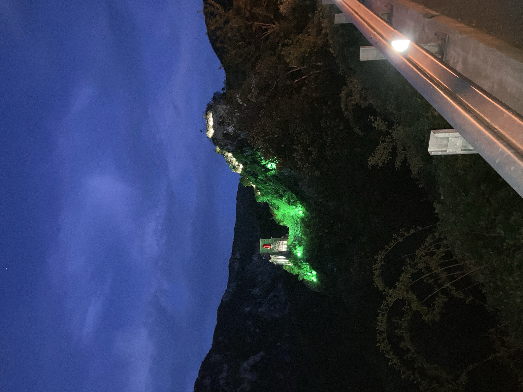 Illuminated hillside structures observed during nighttime hours