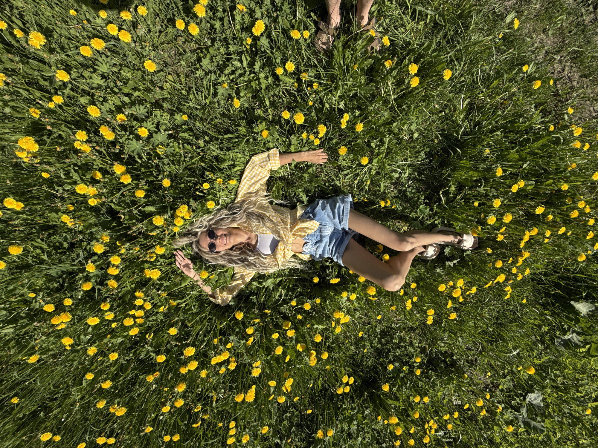 Woman rests in yellow flower field in Шебунино