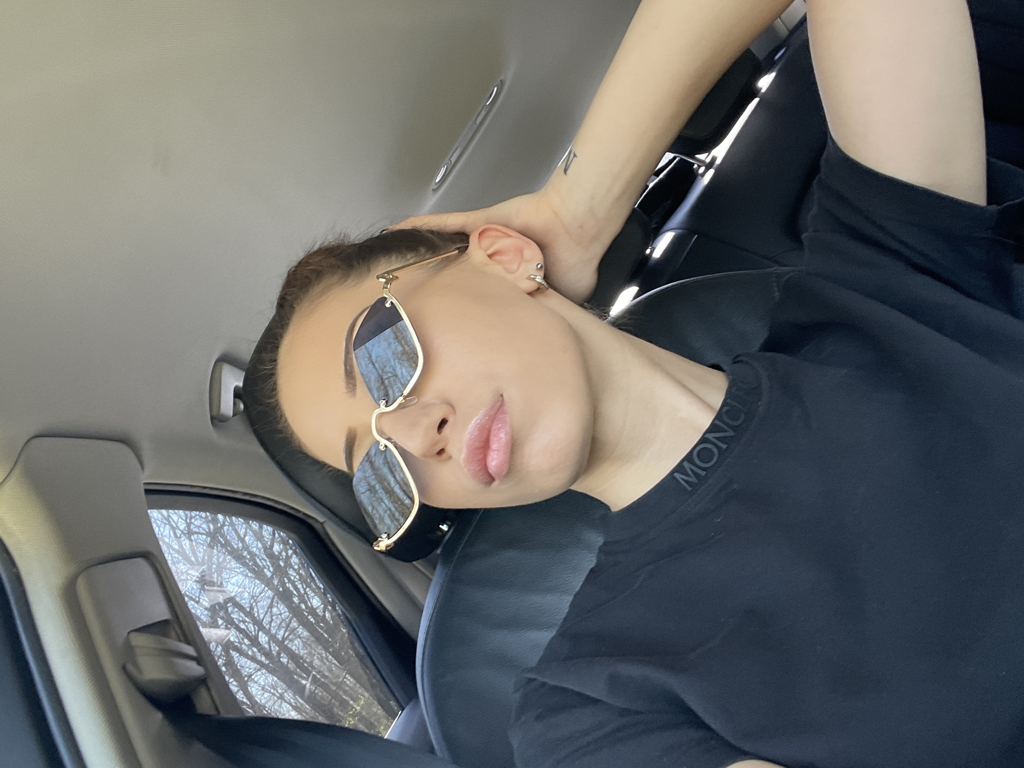 Person rests in car wearing sunglasses in Balvan, Bulgaria