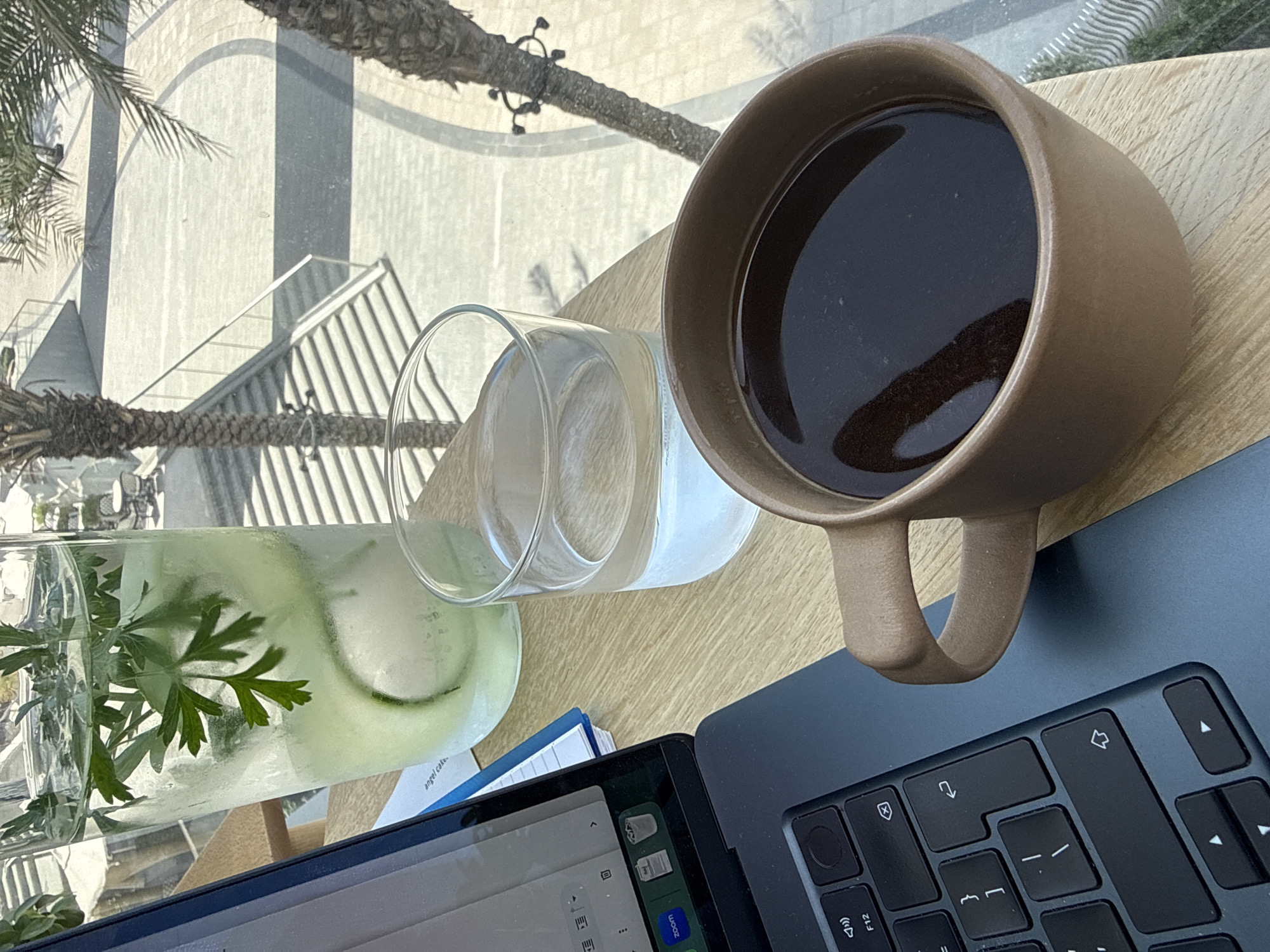 Woman enjoys morning coffee at outdoor Dubai workspace