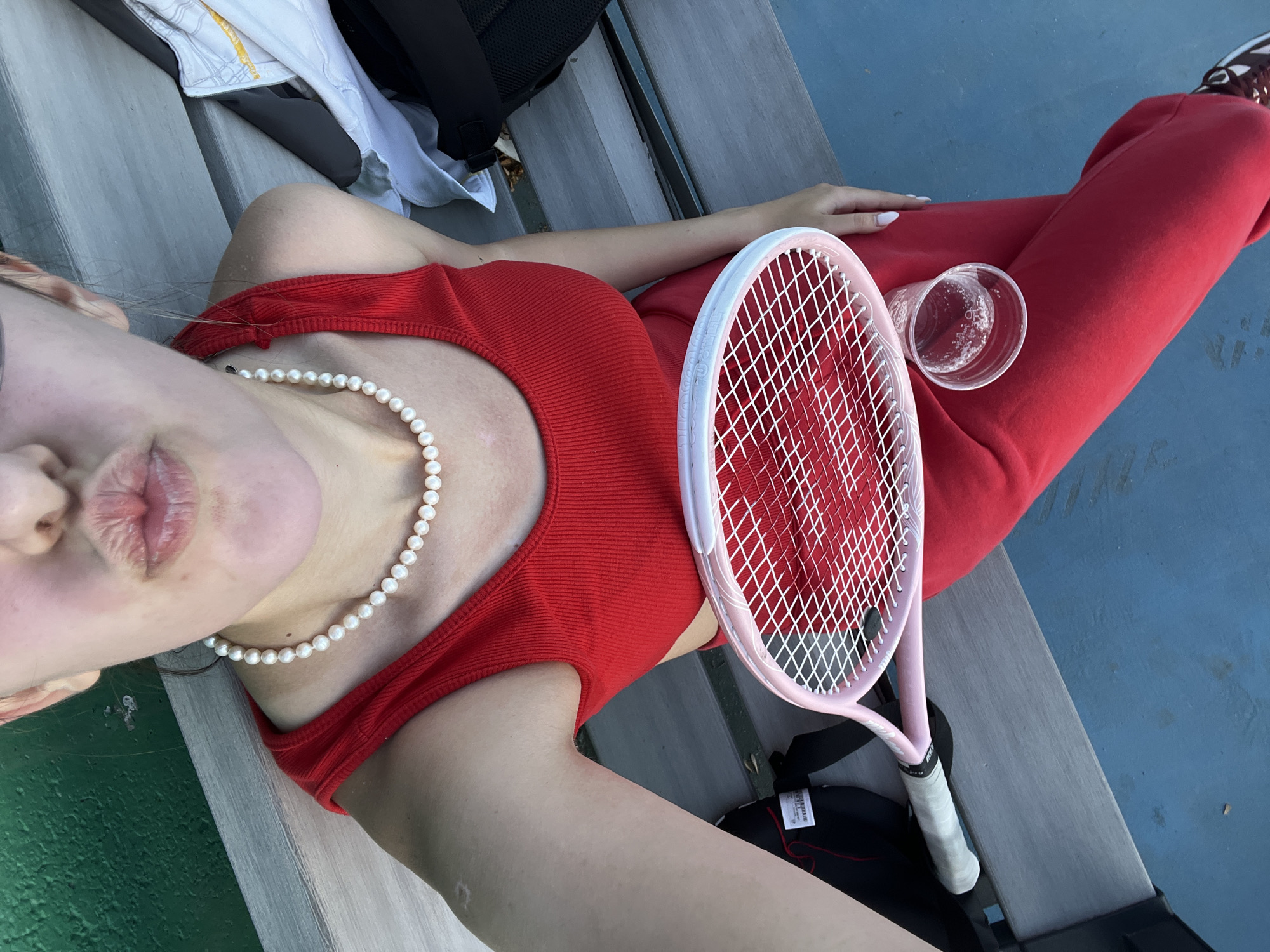 Tennis player takes break on court bleachers in Bulgaria