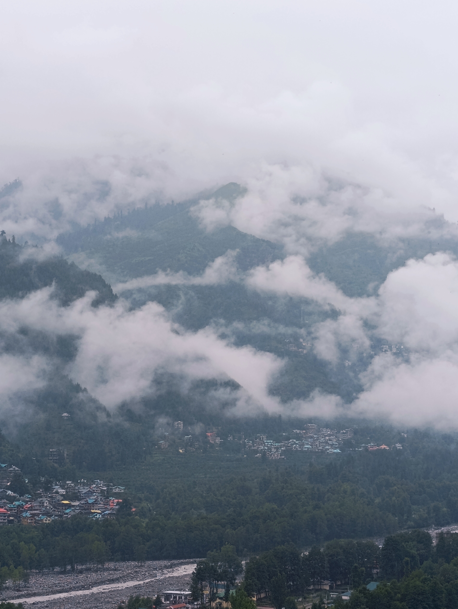 Vashisht hillside town under morning mist and cloud cover