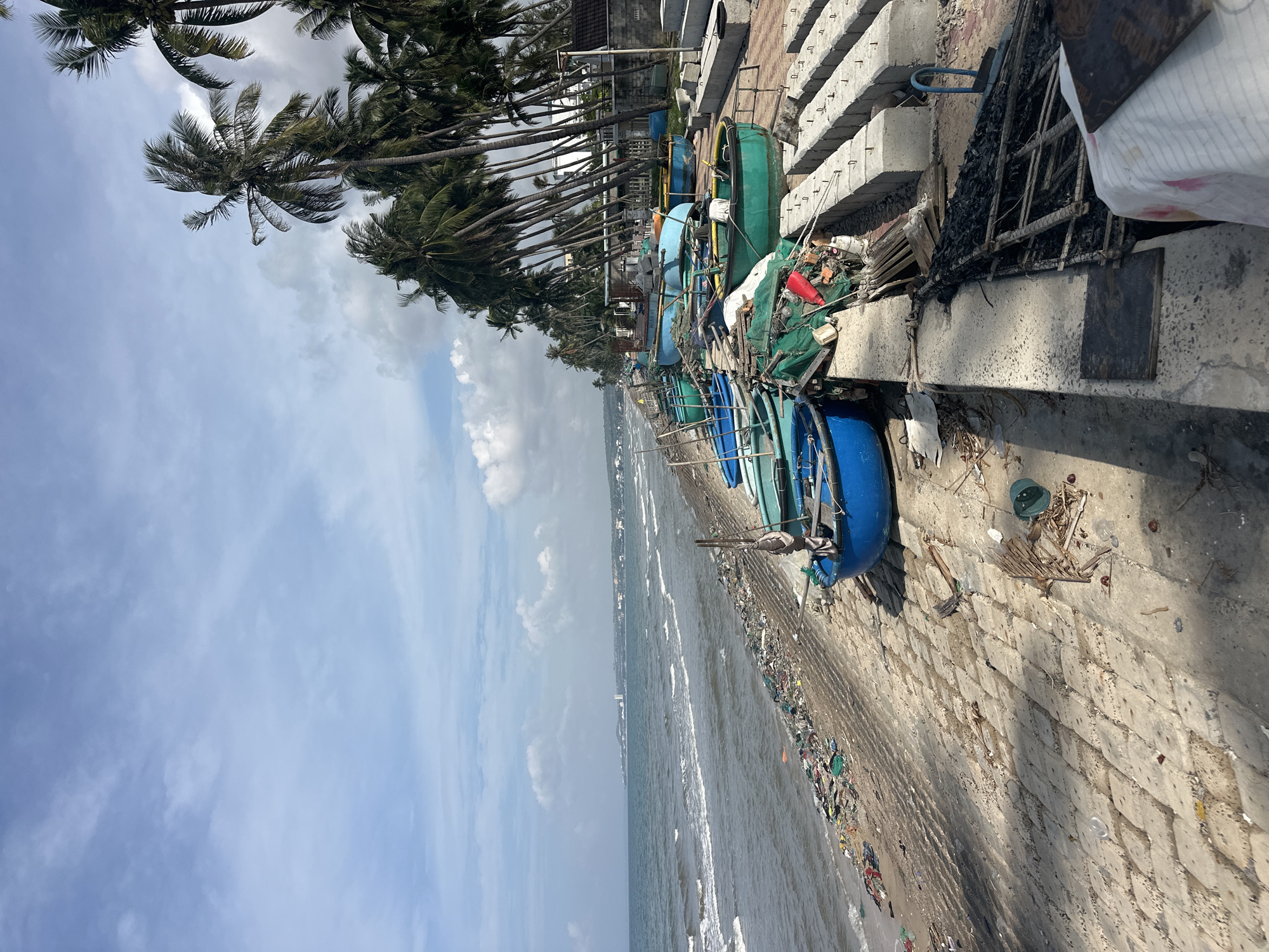 Tropical beach shoreline heavy with plastic and debris pollution