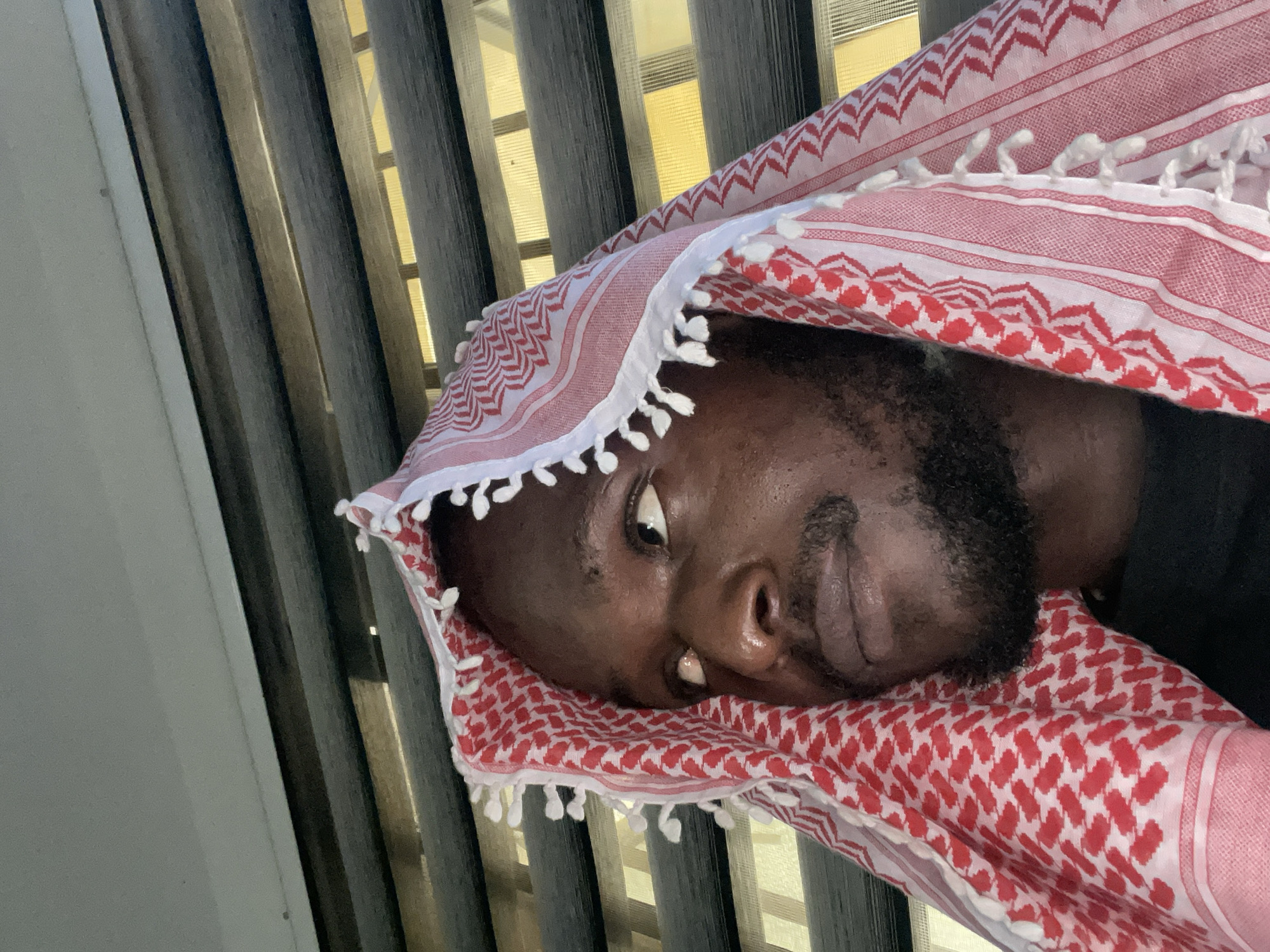 Quiet portrait session in Abuja featuring a red and white keffiyeh