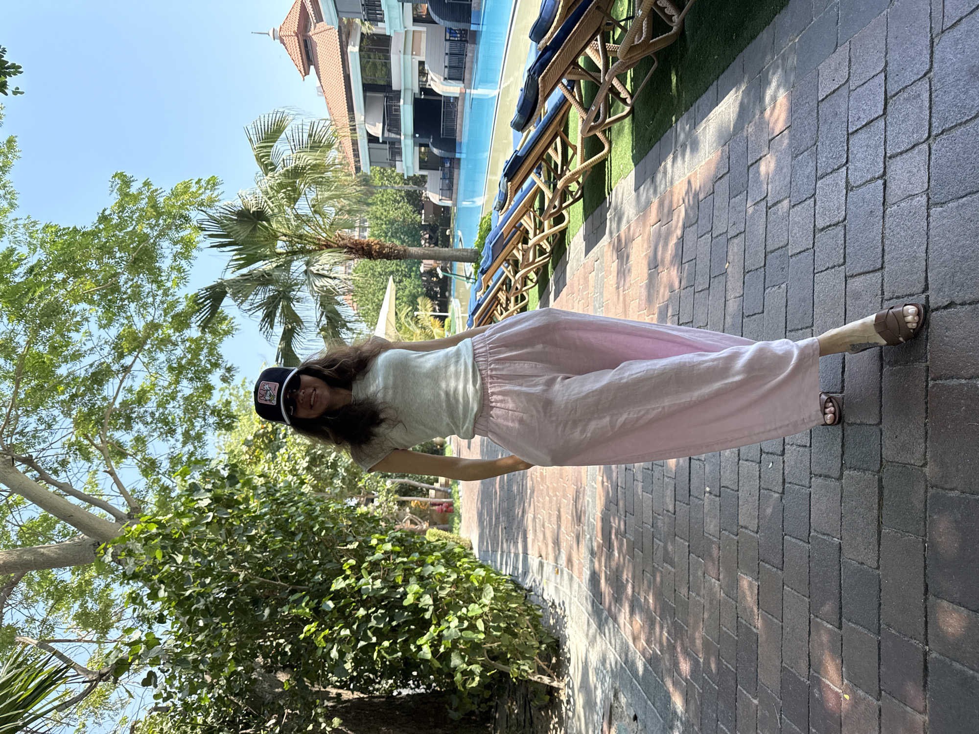 Woman films morning yoga session by Dubai pool