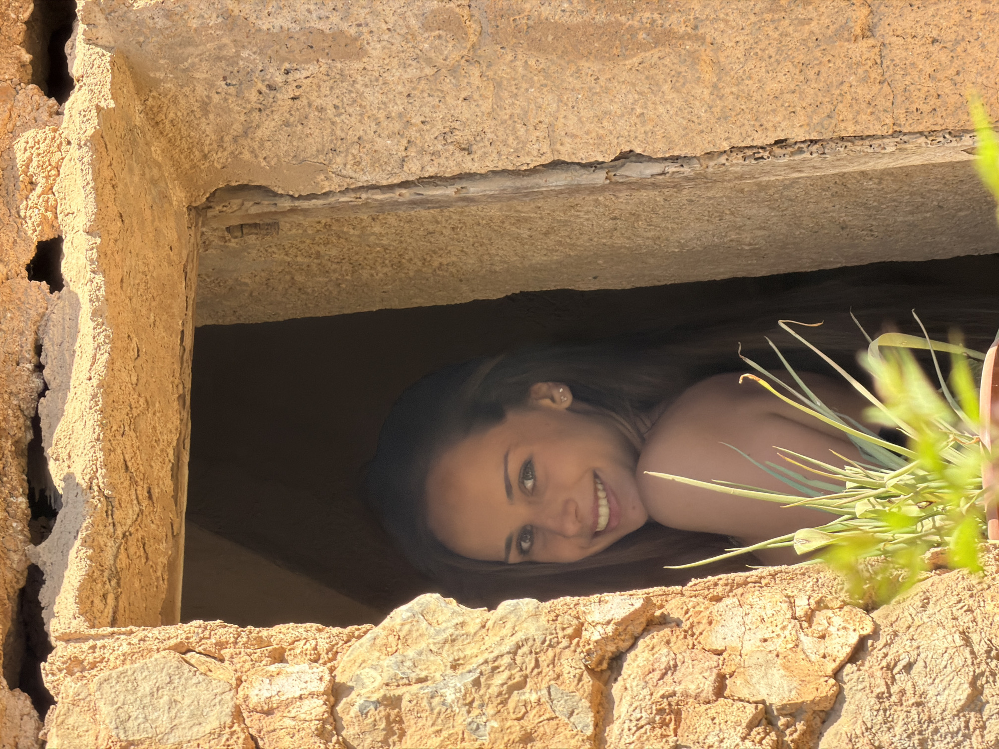Woman photographed at historic stone structures in Bunyola, Spain
