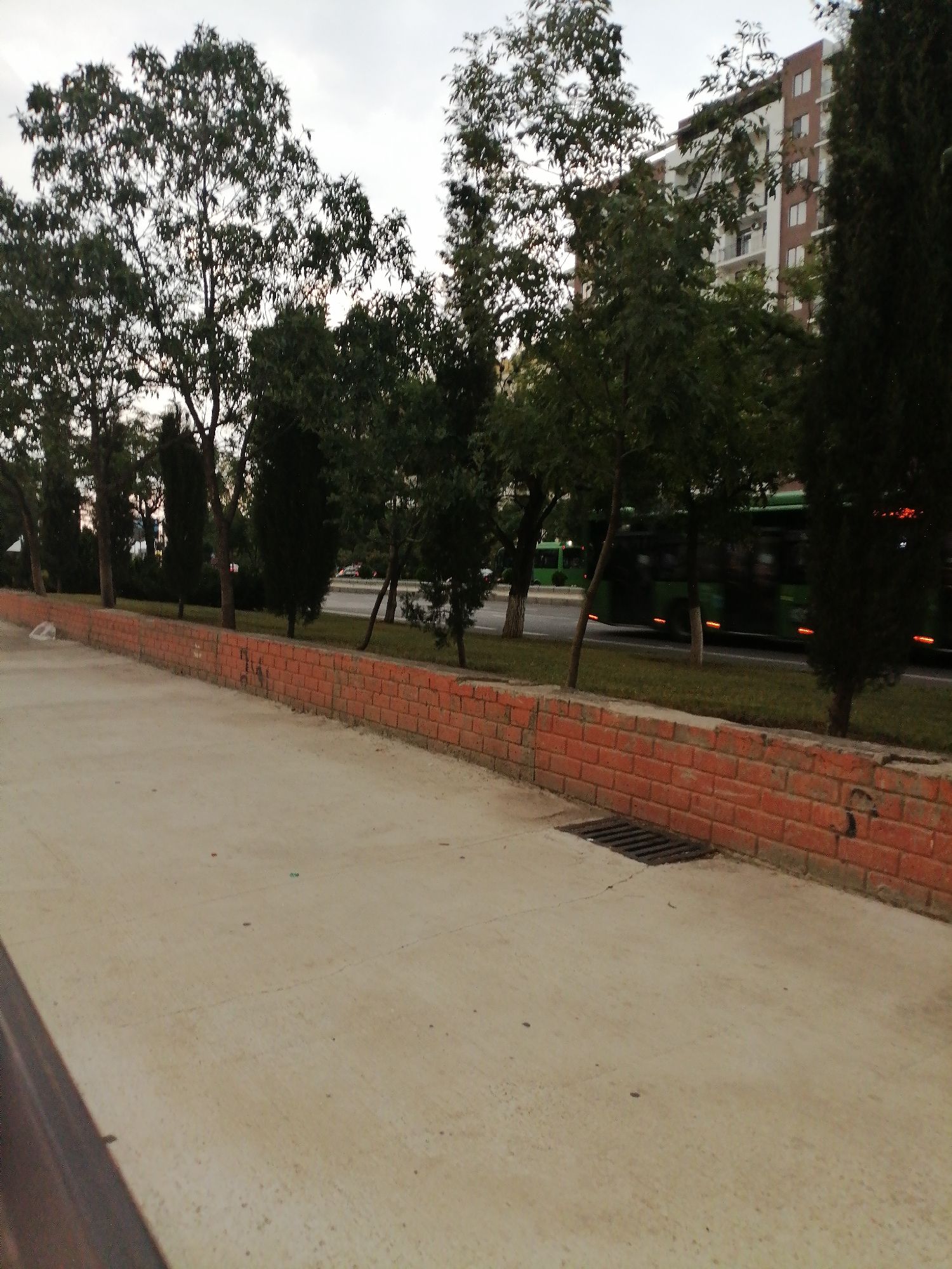 Streetside walkway along a brick wall in Rustavi, Georgia
