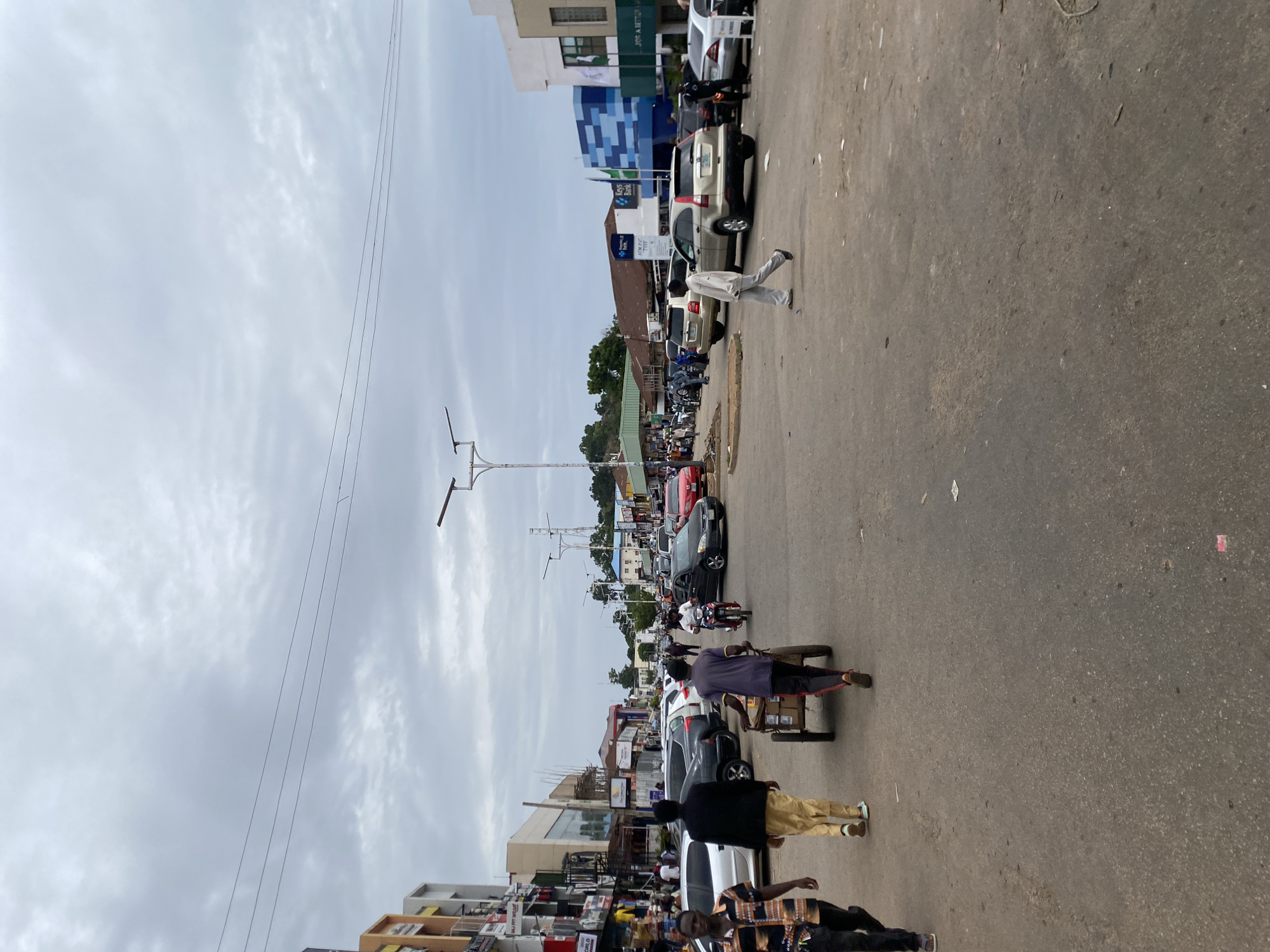 Midday street life across a busy Jos commercial district