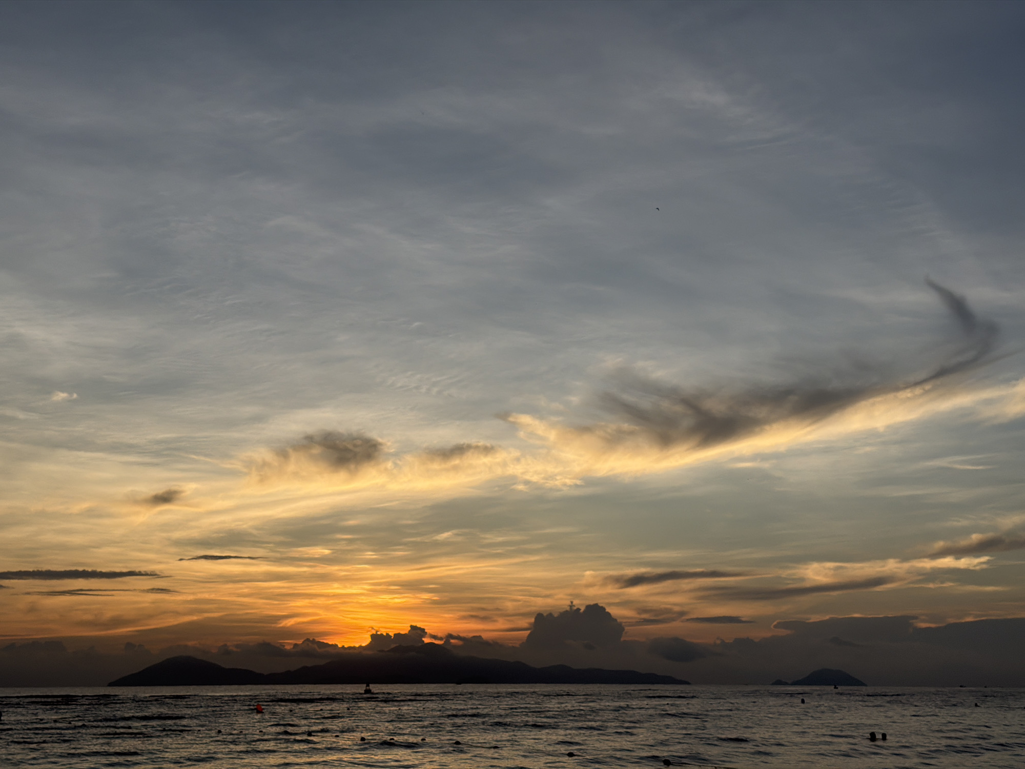 Hoi An sunset unfolds across sky and coastline