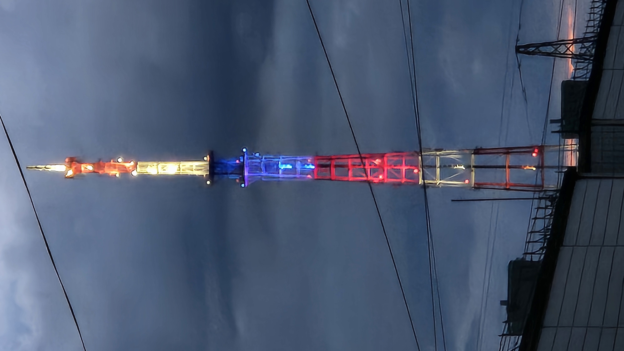 Patriotic-lit tower observed against dark evening sky