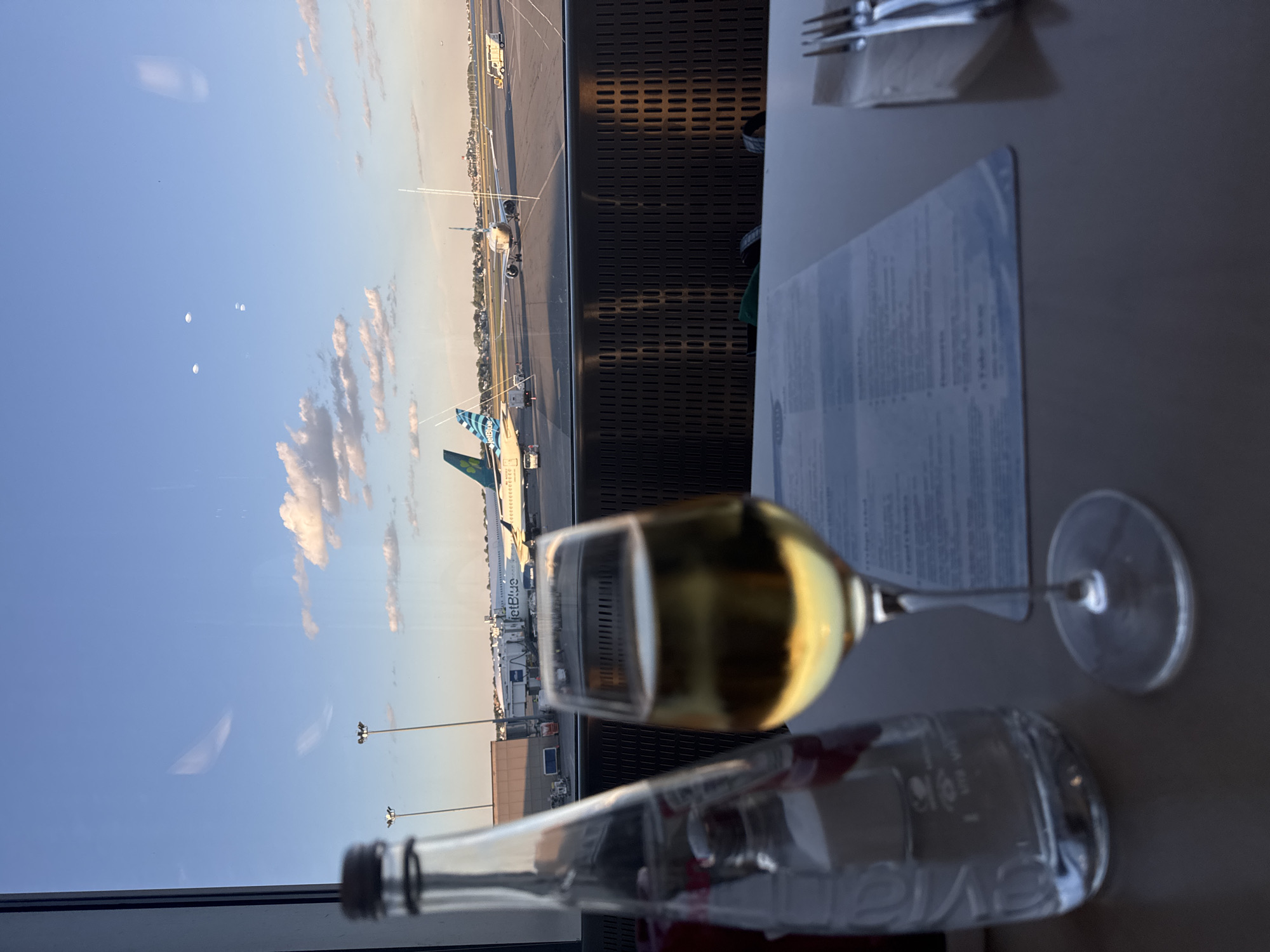 Inside Logan Airport's lounge, planes visible on the tarmac