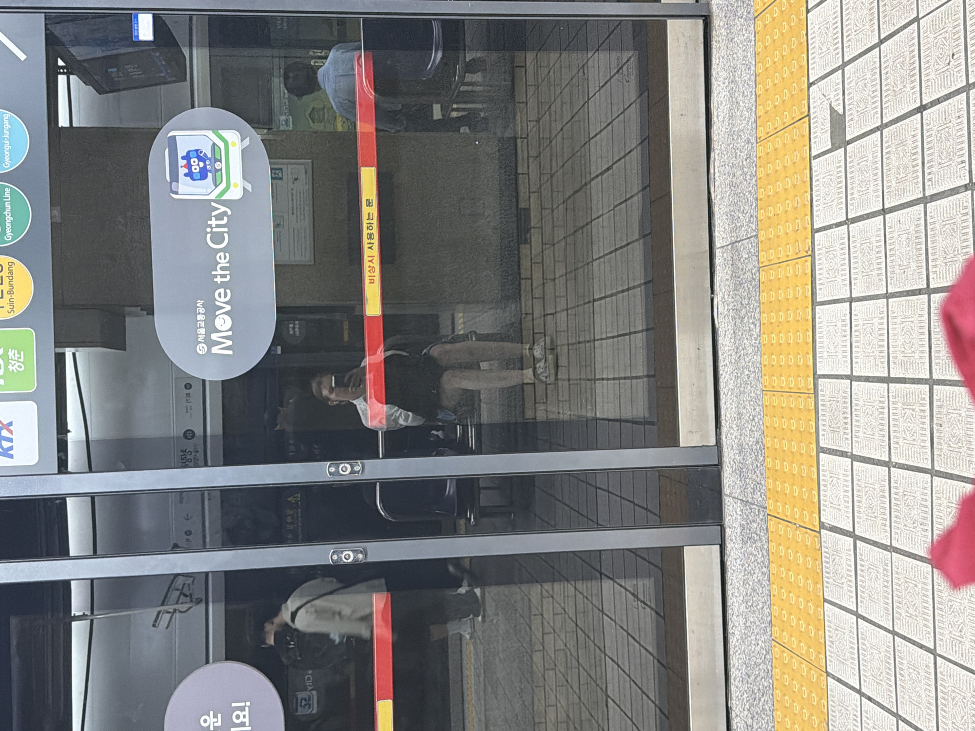 Seoul subway platform, white shirt and lavender earbud