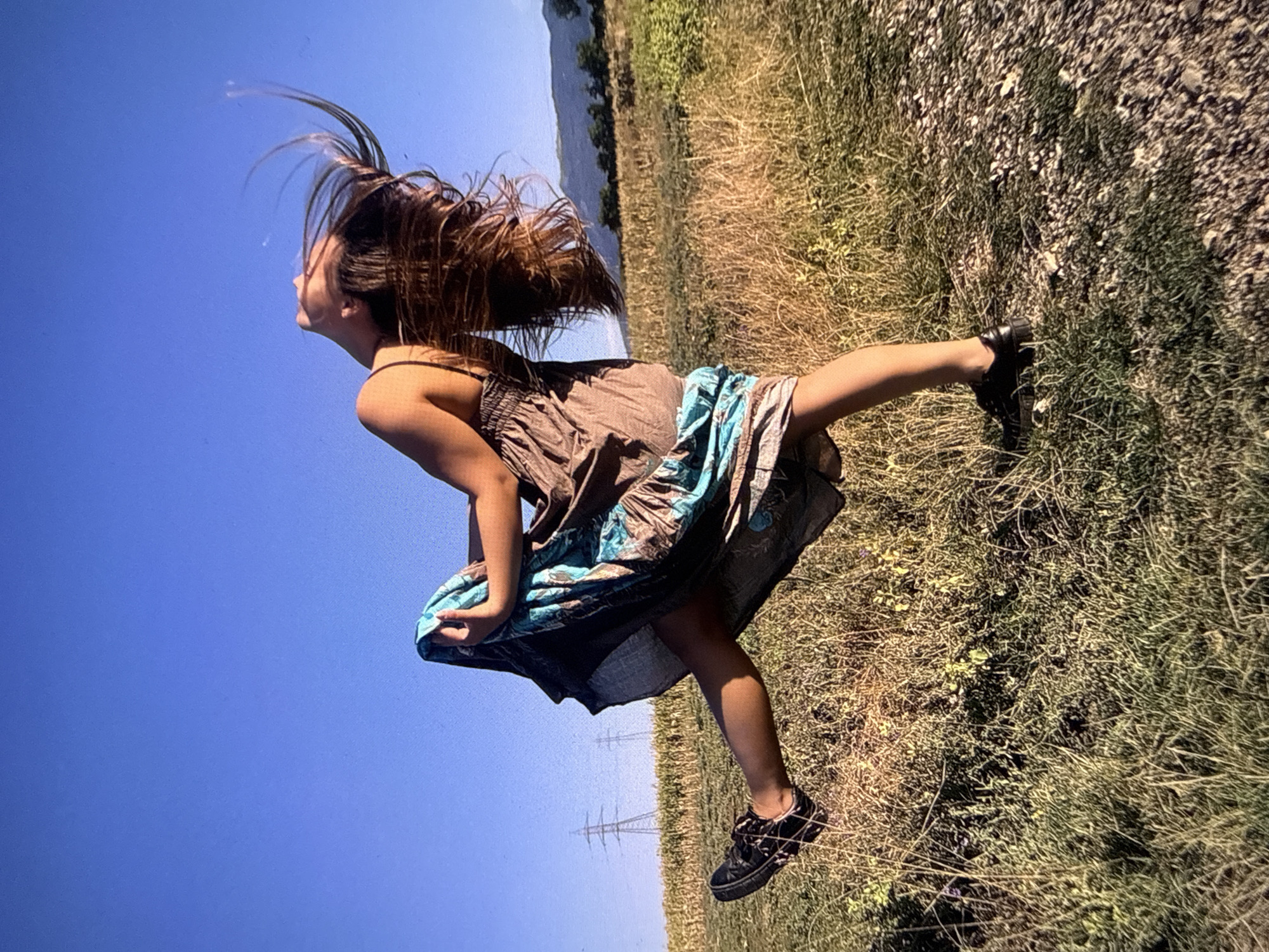 Woman captured mid-movement on grassy field in Sofia