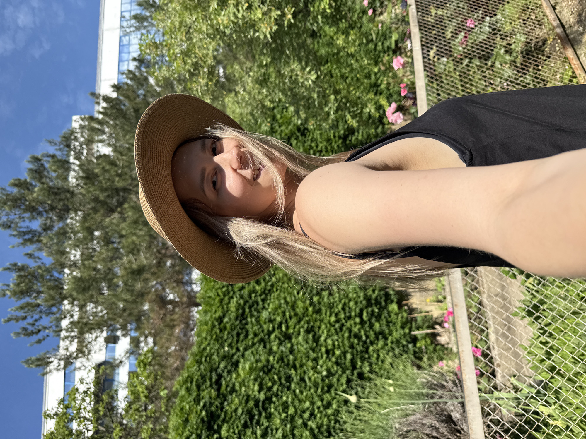 Tourist in straw hat sightseeing around coastal Nebug, Russia