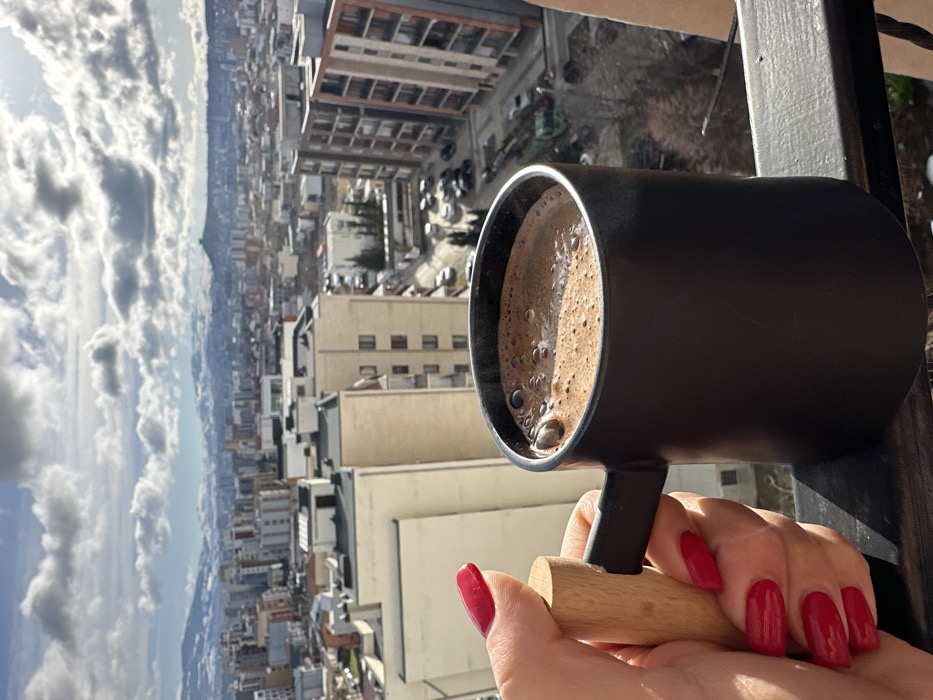 Morning breakfast routine documented in Tbilisi apartment overlooking cityscape