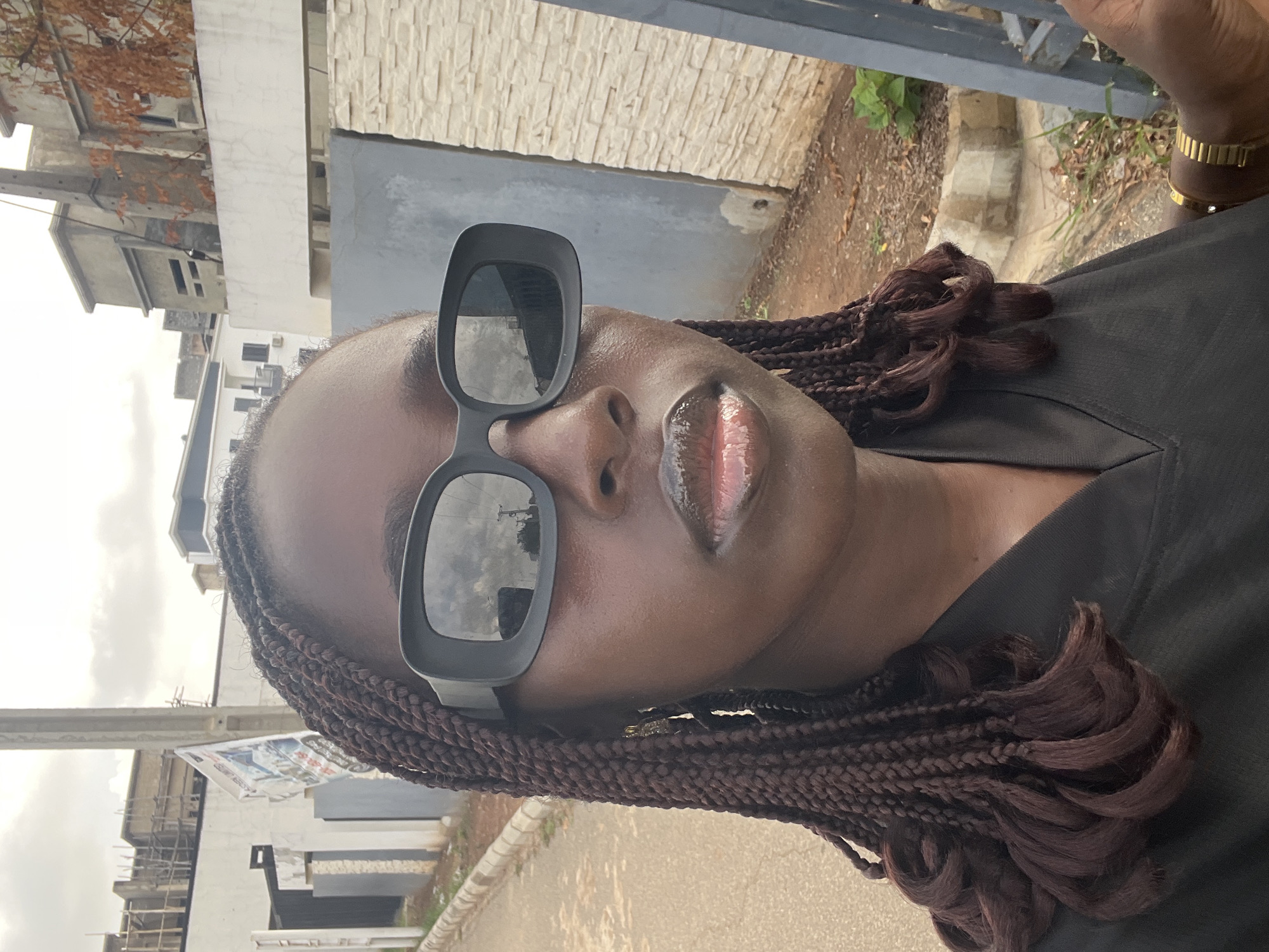 Person takes selfies on residential street in Karum, Nigeria