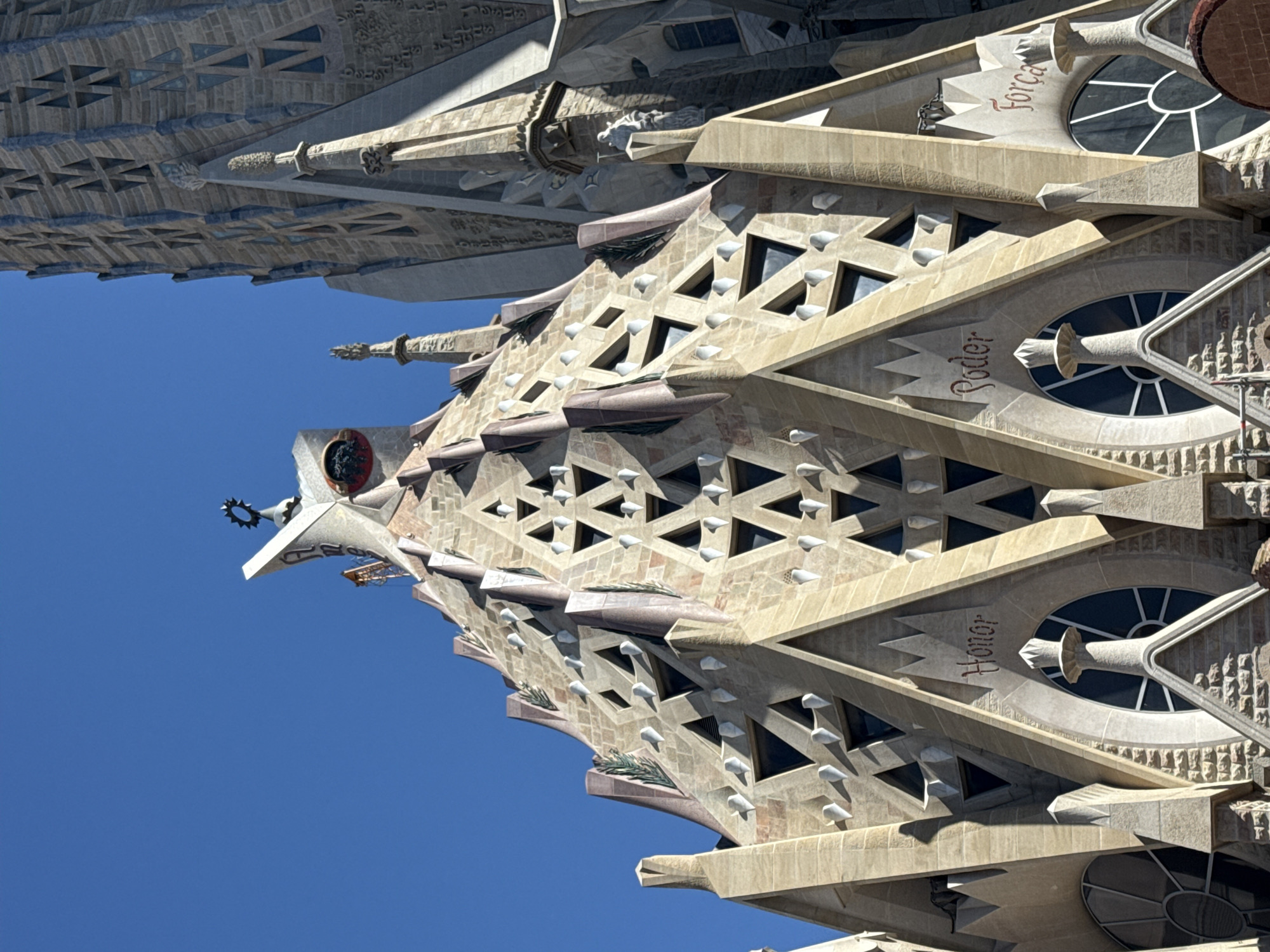 Tourists gather at Barcelona's Sagrada Familia on sunny morning