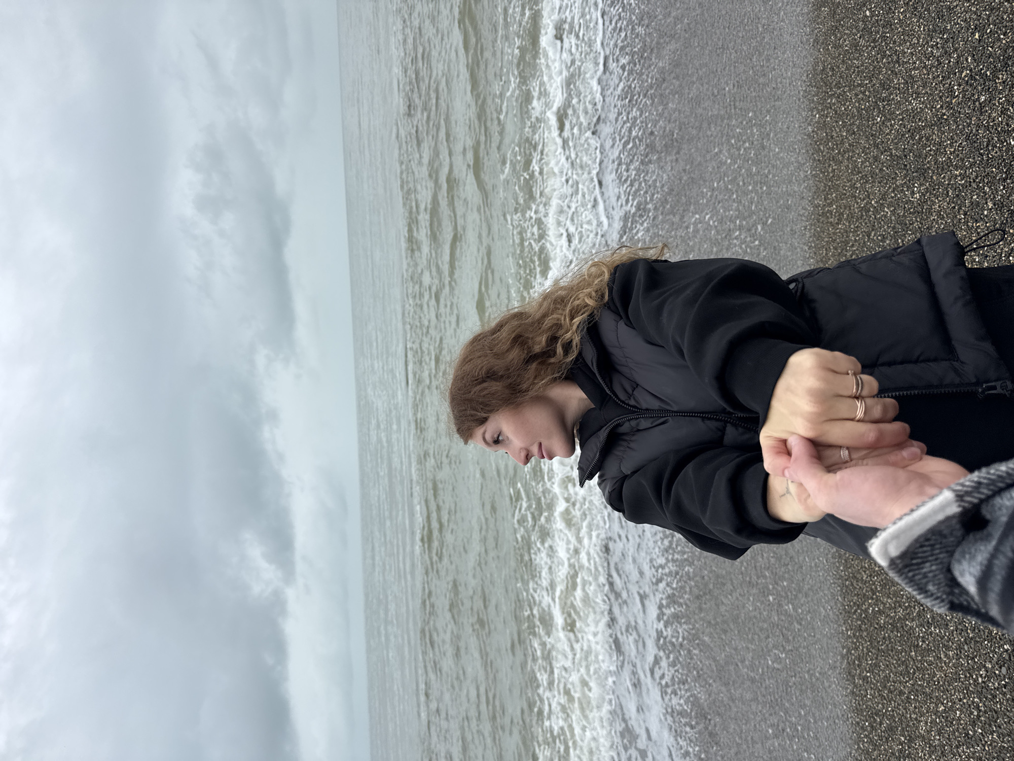 Couple holds hands on Chabkwara beach, Abkhazia
