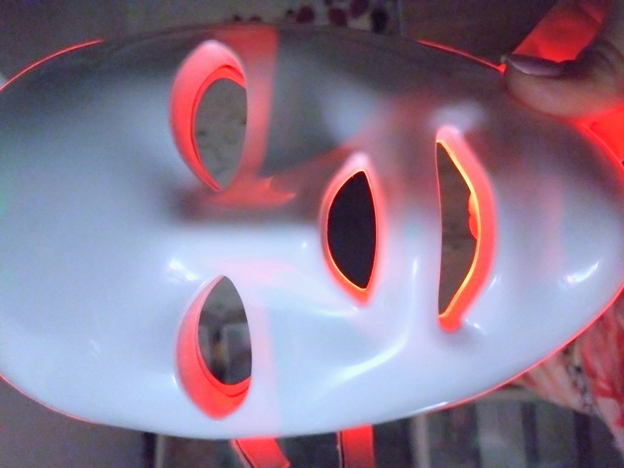 LED face mask examined against a city sunset backdrop