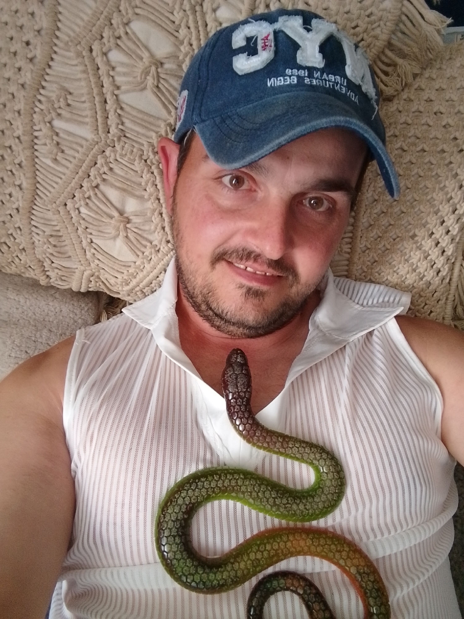 Relaxed pose with snake accessory against a macrame cushion, Wedel