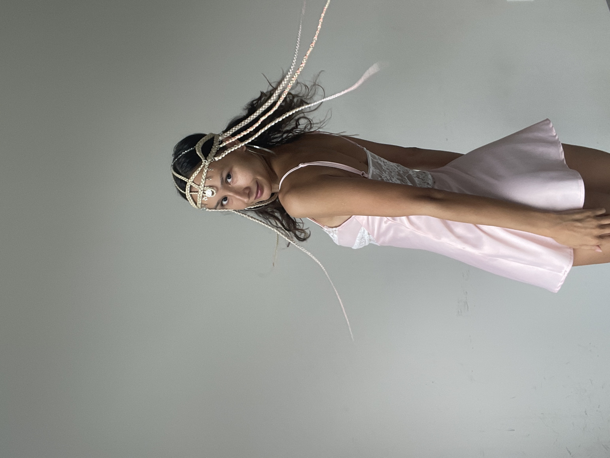 Pink slip dress and beaded braids in a Mũi Né studio shoot
