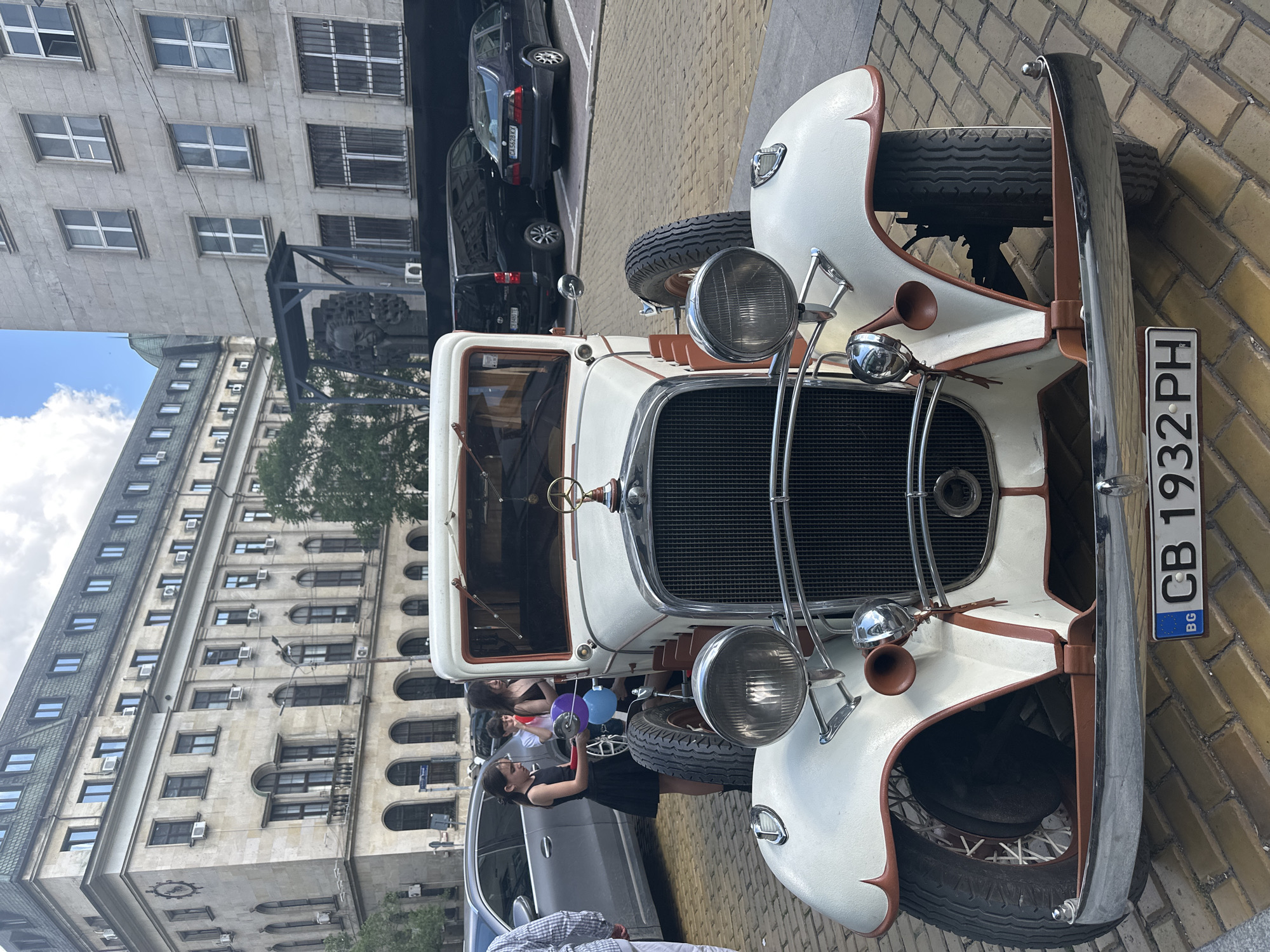 Vintage white classic car spotted on Sofia's brick streets