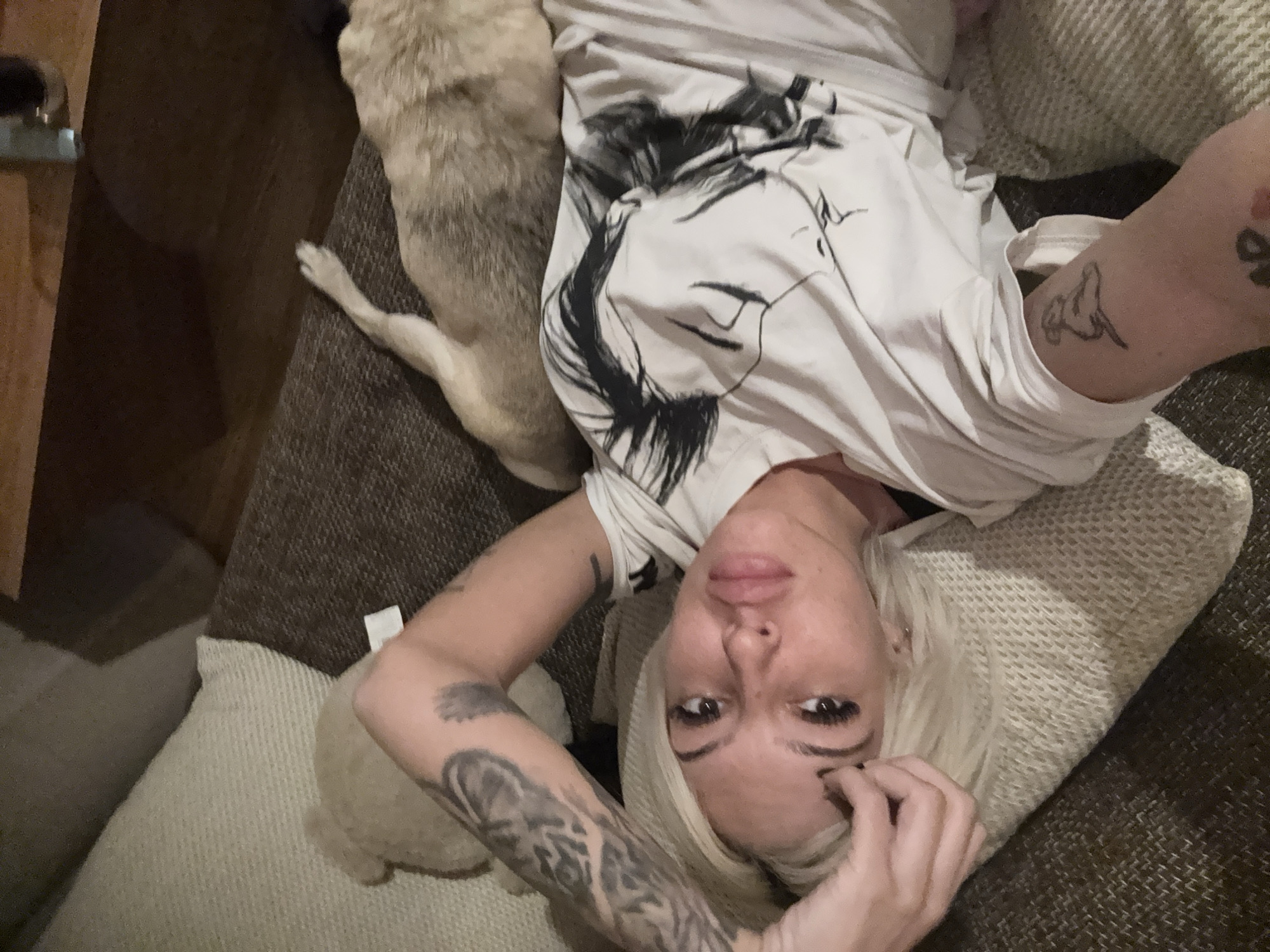 Woman takes selfies with pug in green-walled room
