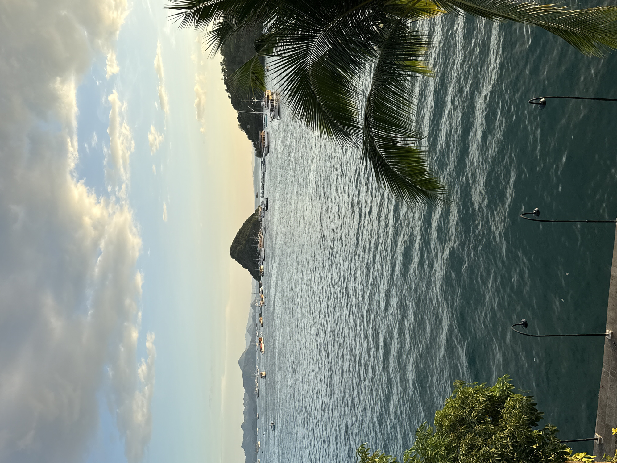 Tourist captures scenic harbor and market views in Labuan Bajo