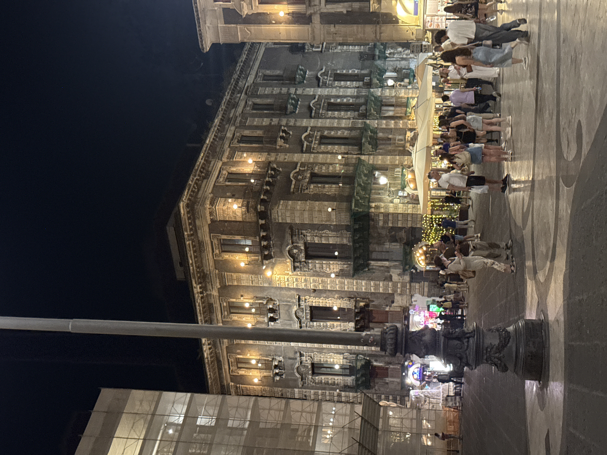 Nighttime street activity documented in historic Catania district