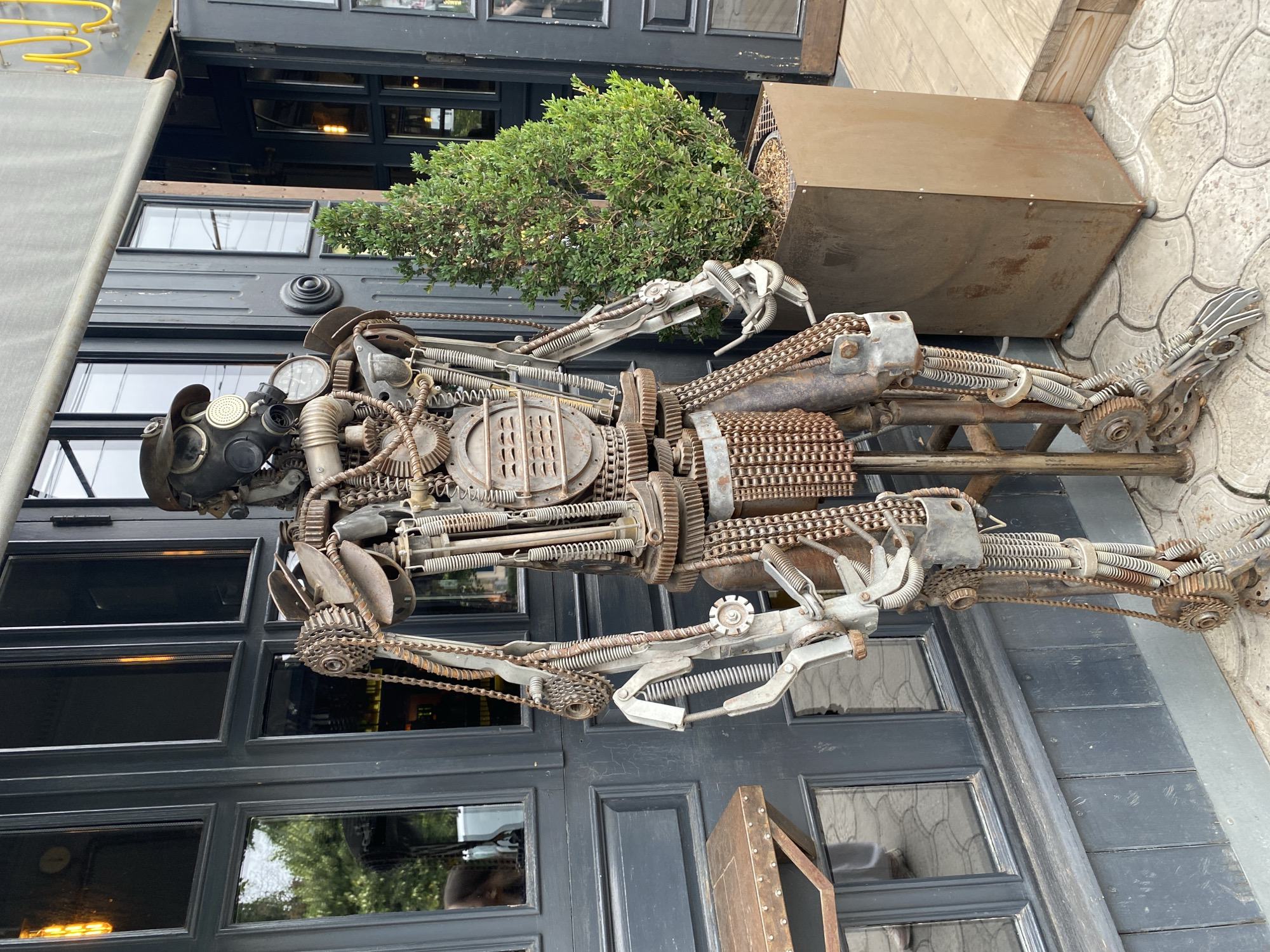 Scrap metal steampunk robot sculpture outside a Mykolaiv building