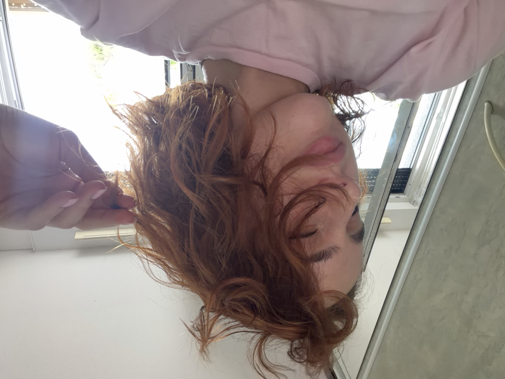 Person takes selfies with laptop reflection in Strasbourg