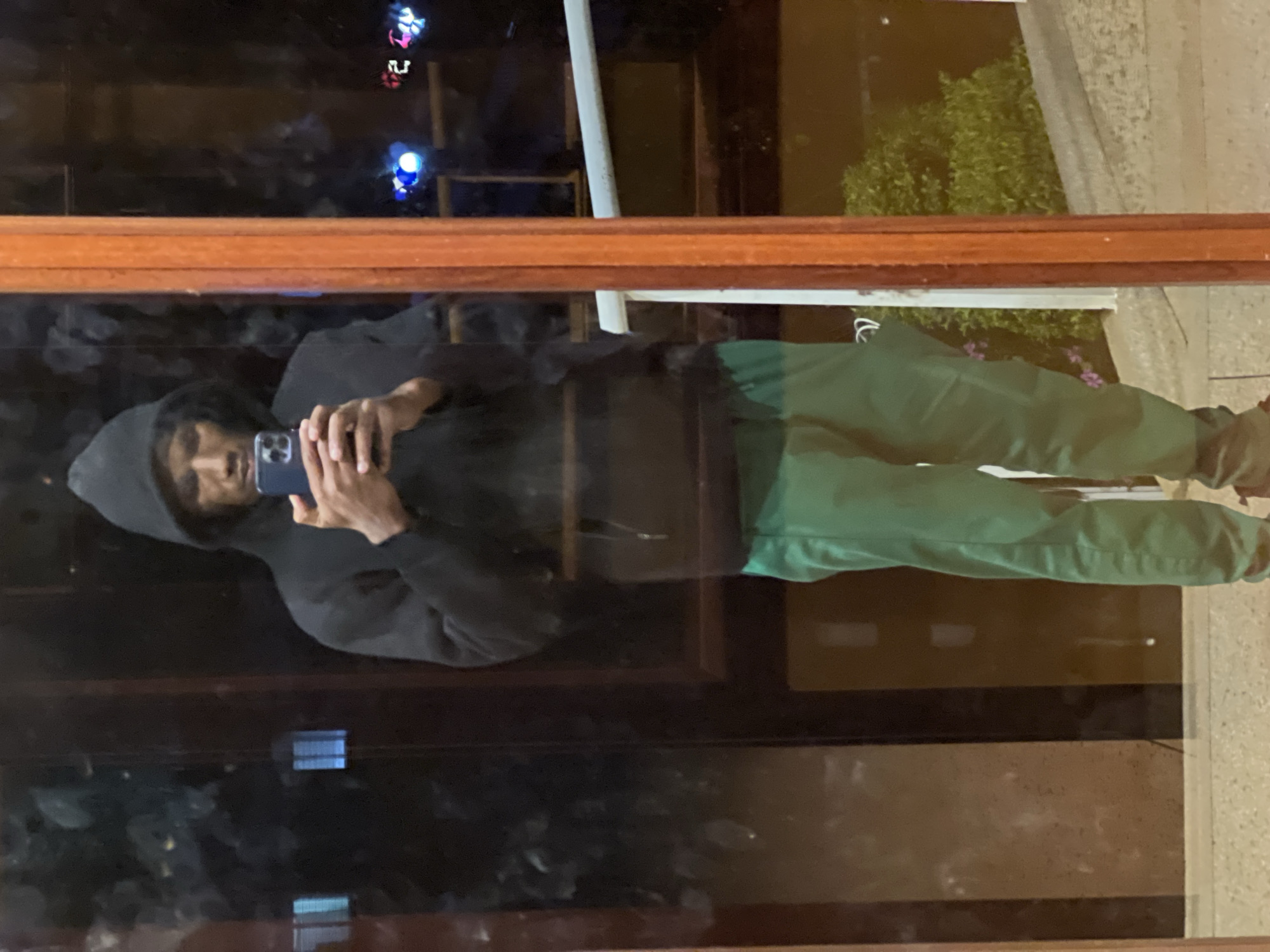 Person takes selfie in window reflection in Nairobi
