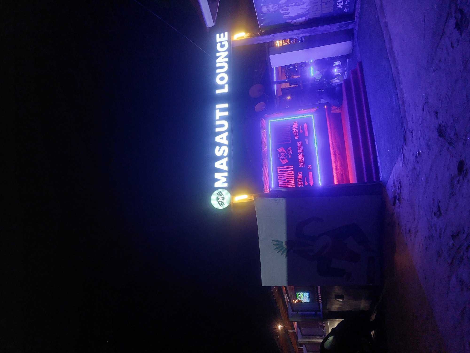 Masauti Lounge illuminated signage captured at night in Dar es Salaam
