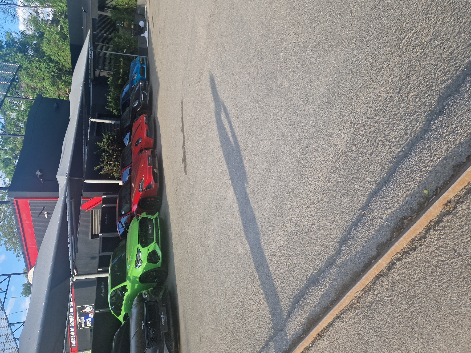 Colorful cars parked alongside building captured in everyday scene