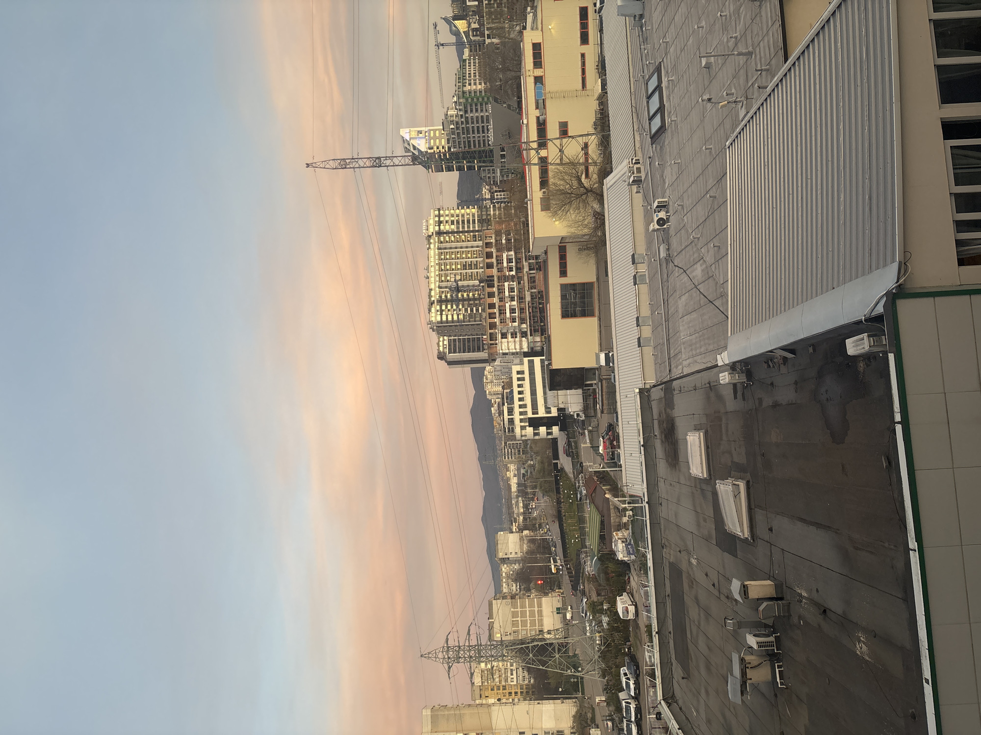 Twilight cityscape observed in Sofia with mountain backdrop