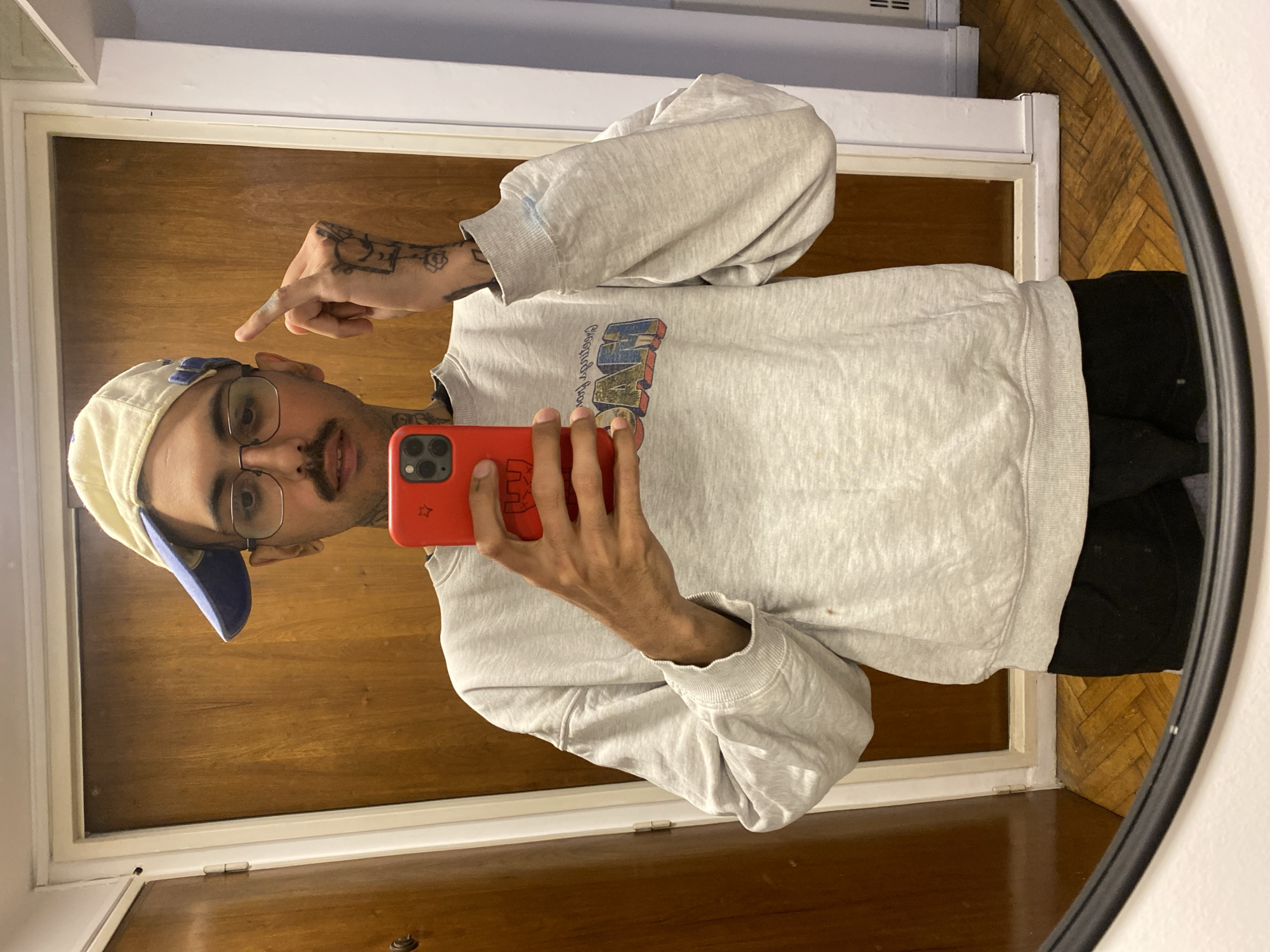 Young man takes mirror selfie in Buenos Aires apartment