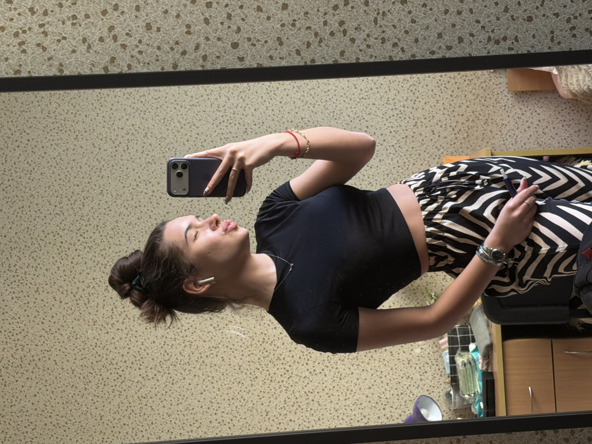 Woman takes selfies in Sofia apartment overlooking cityscape
