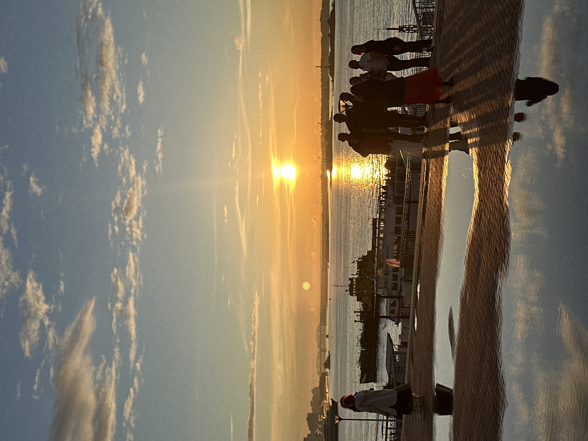 Golden hour on an urban waterfront promenade at sunset