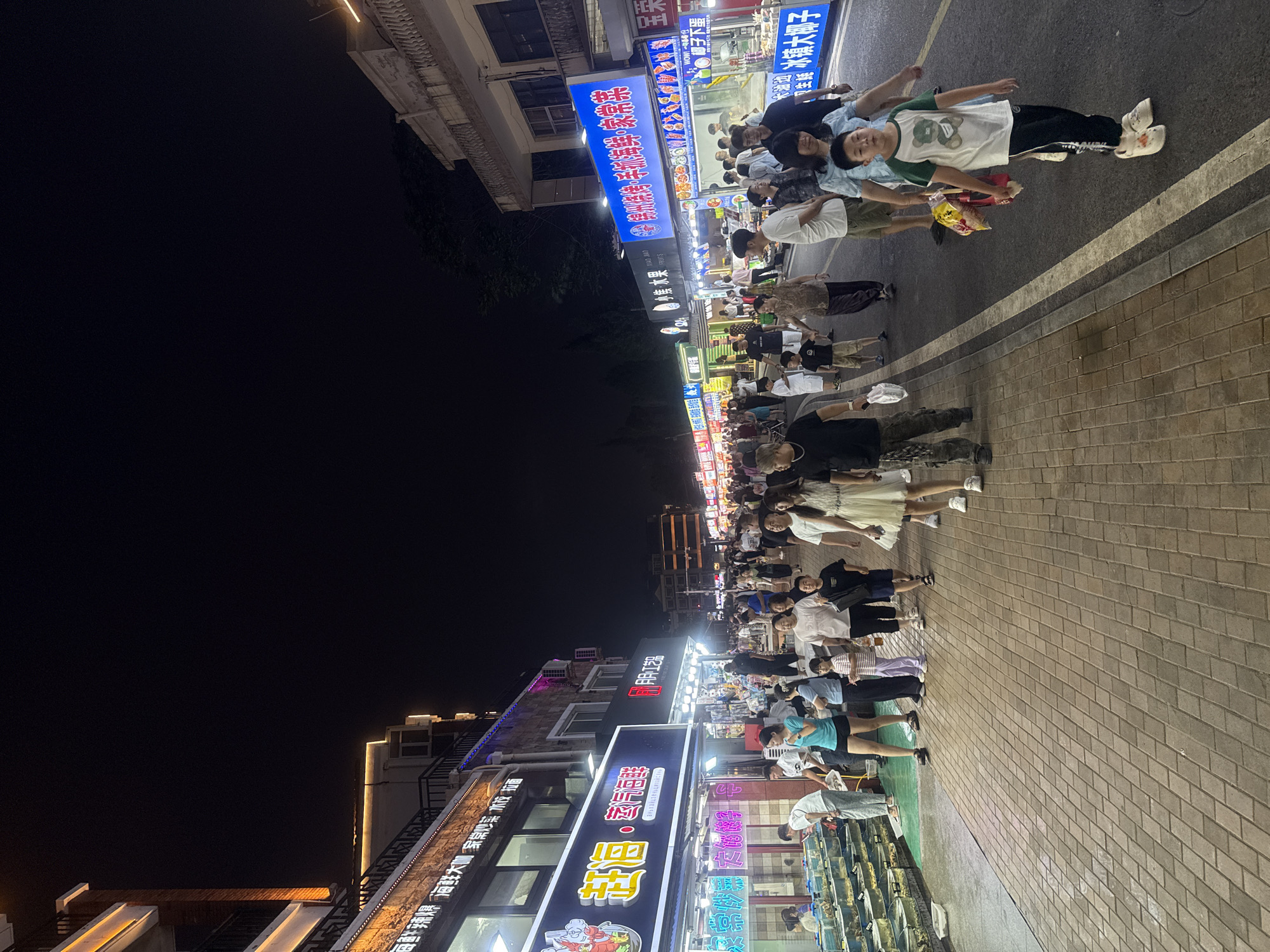 Qinhuangdao night market buzzing with food stalls and foot traffic