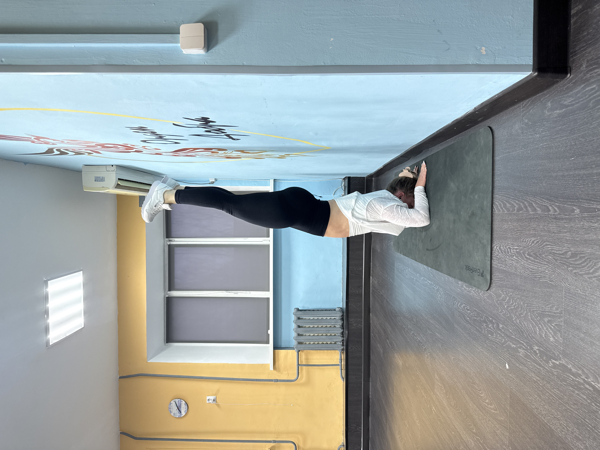 Woman photographed smiling in corridor, Chaikovsky Russia