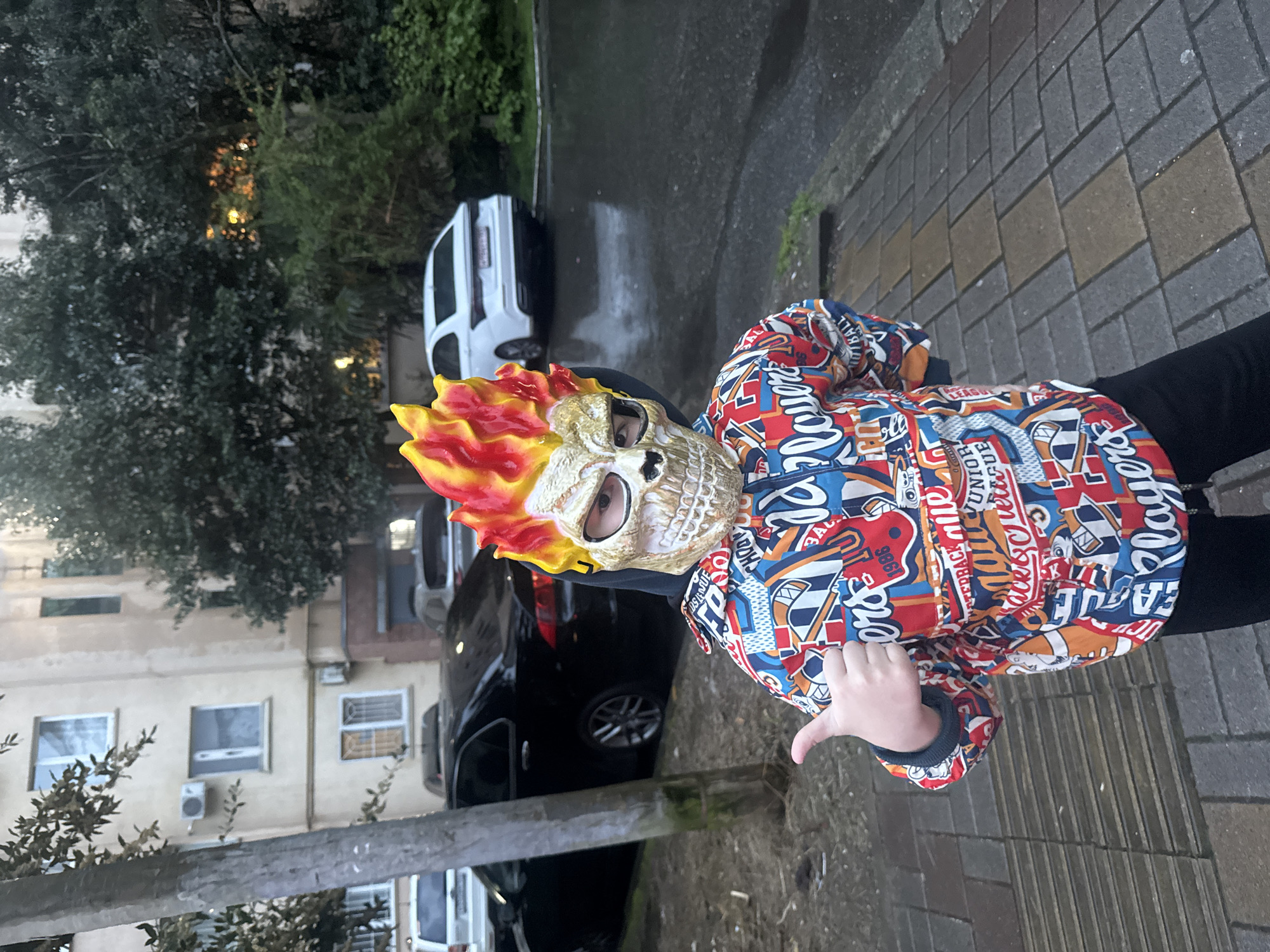 Child in Ghost Rider mask gives thumbs-down in Sochi