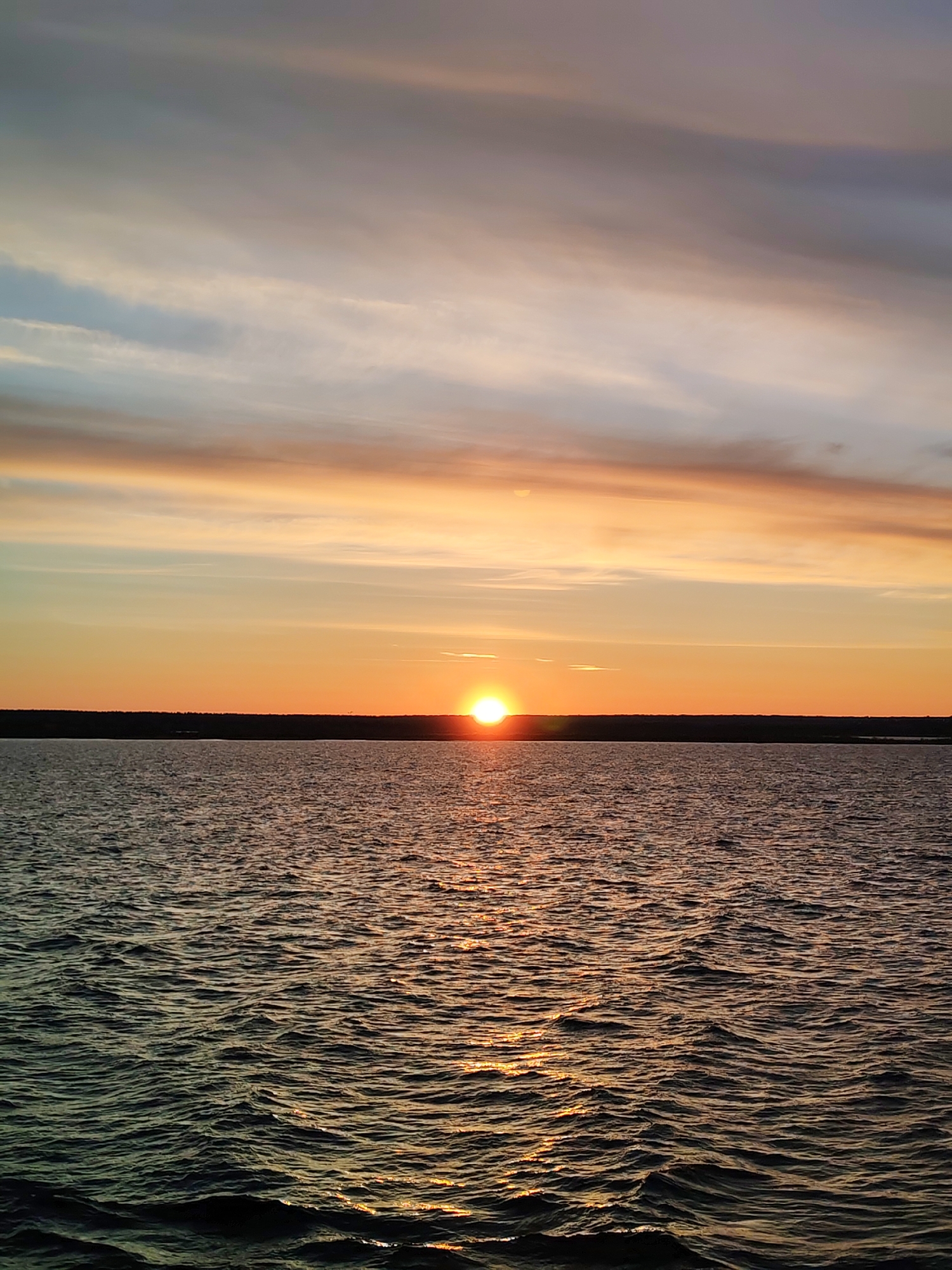 Sunset observed over water in Vasil'evskoe, Russia