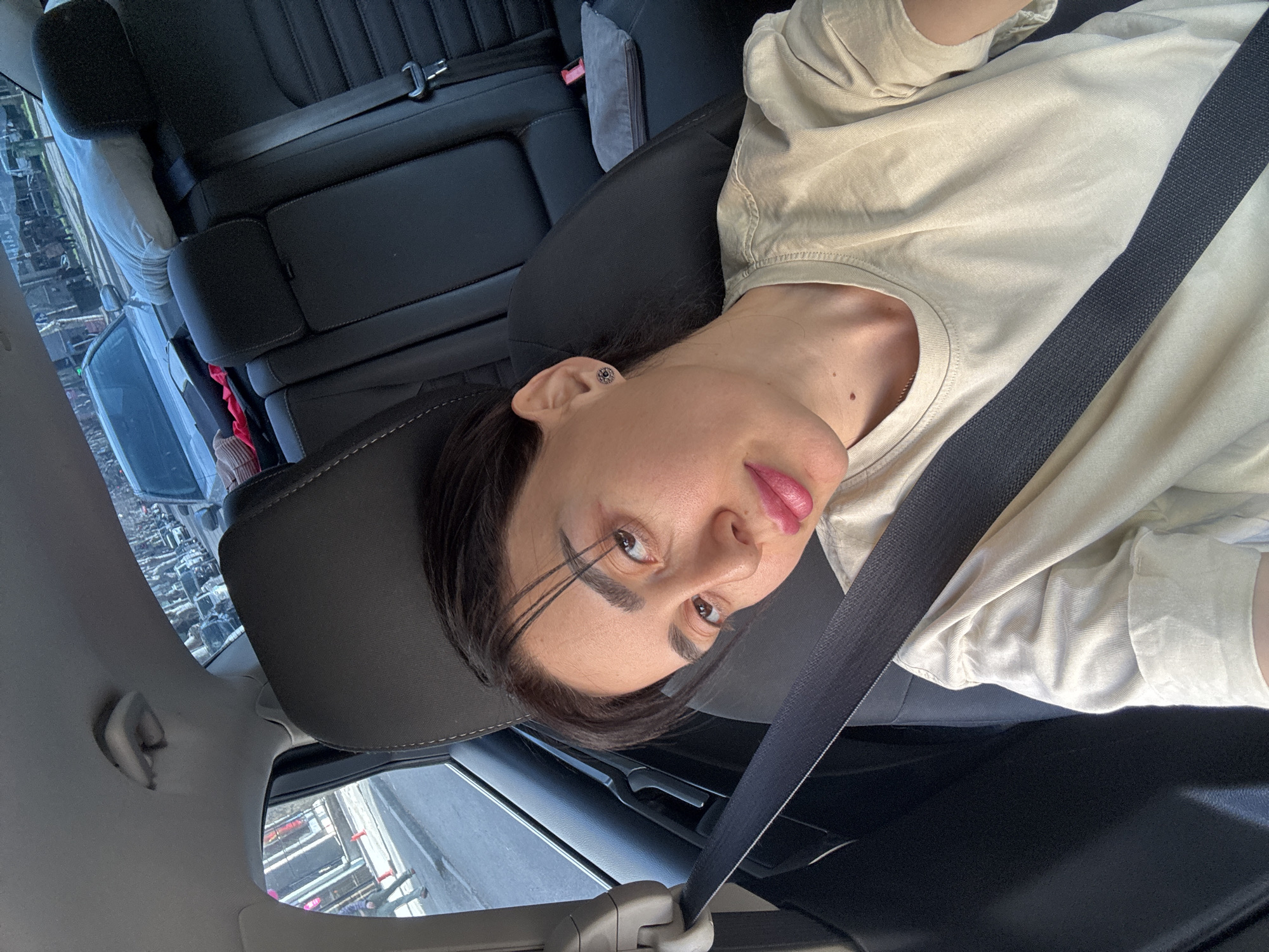 Woman documents car journey through Tbilisi with multiple selfies